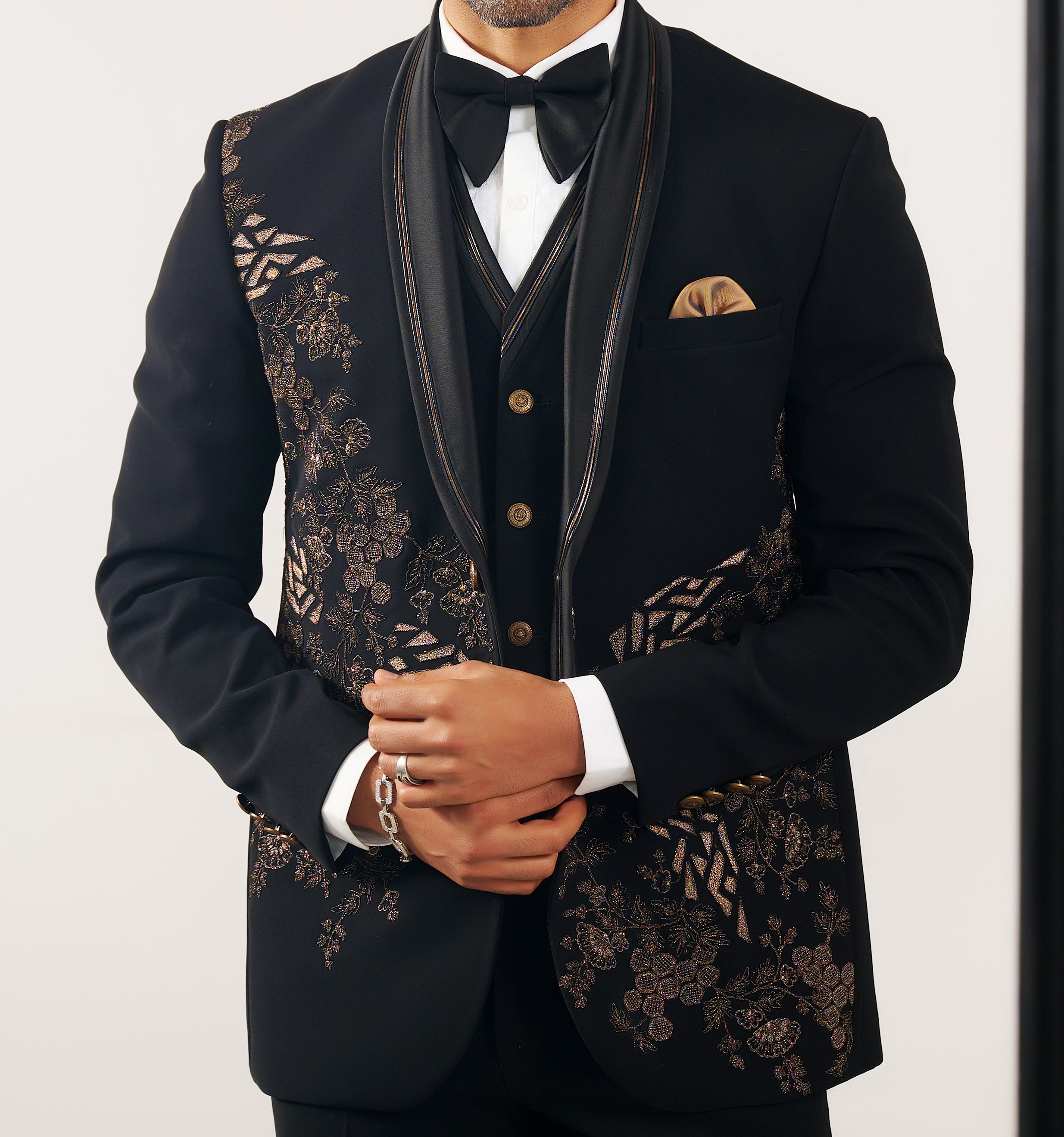 A trendy black party wear suit with embroidered accents, modern Indian fashion.