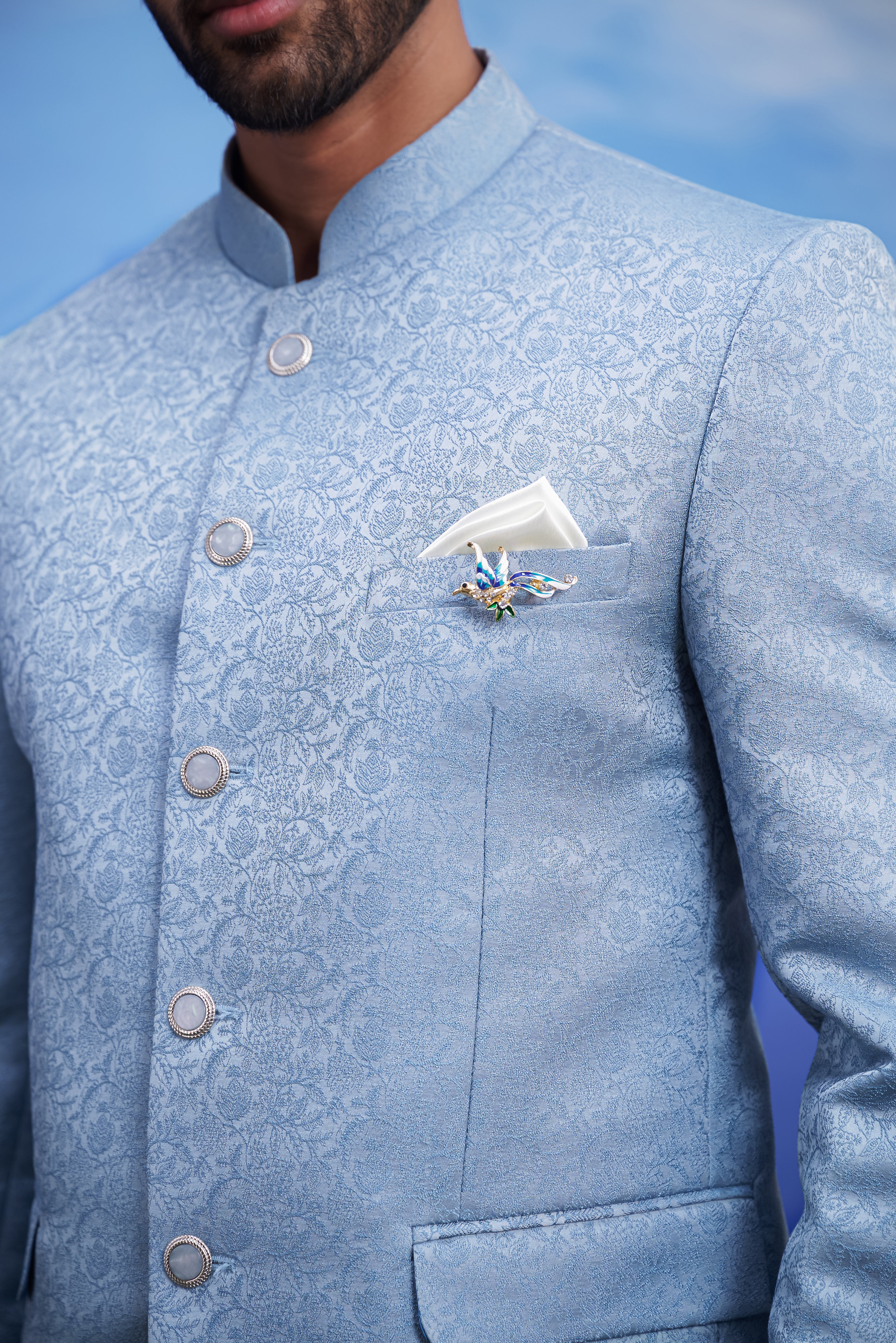 Men's blue Bandhgala suit with jacquard pattern, displayed on a product page with size options.