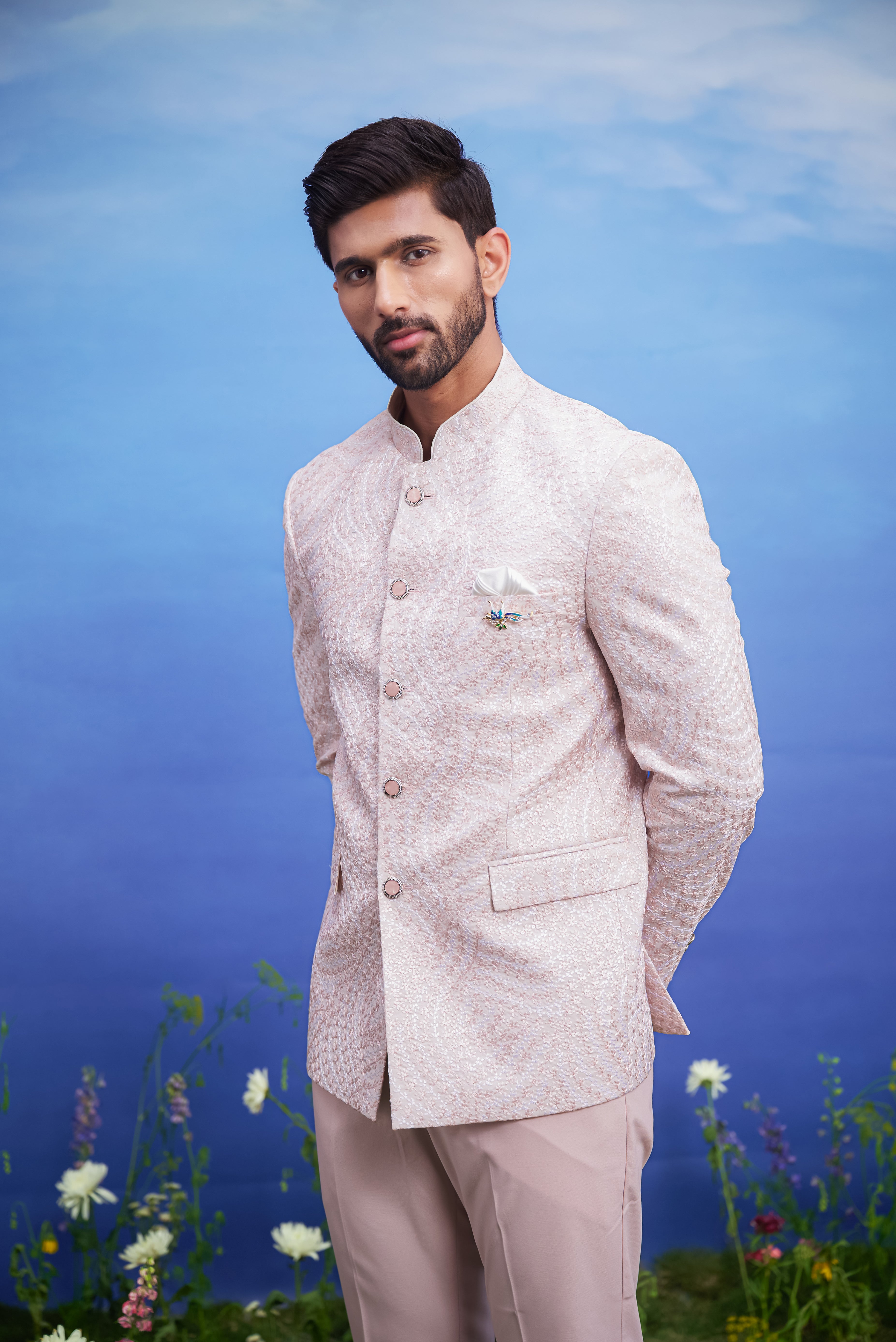 Men's pink Bandhgala suit with embroidery, displayed on a product page with size options.