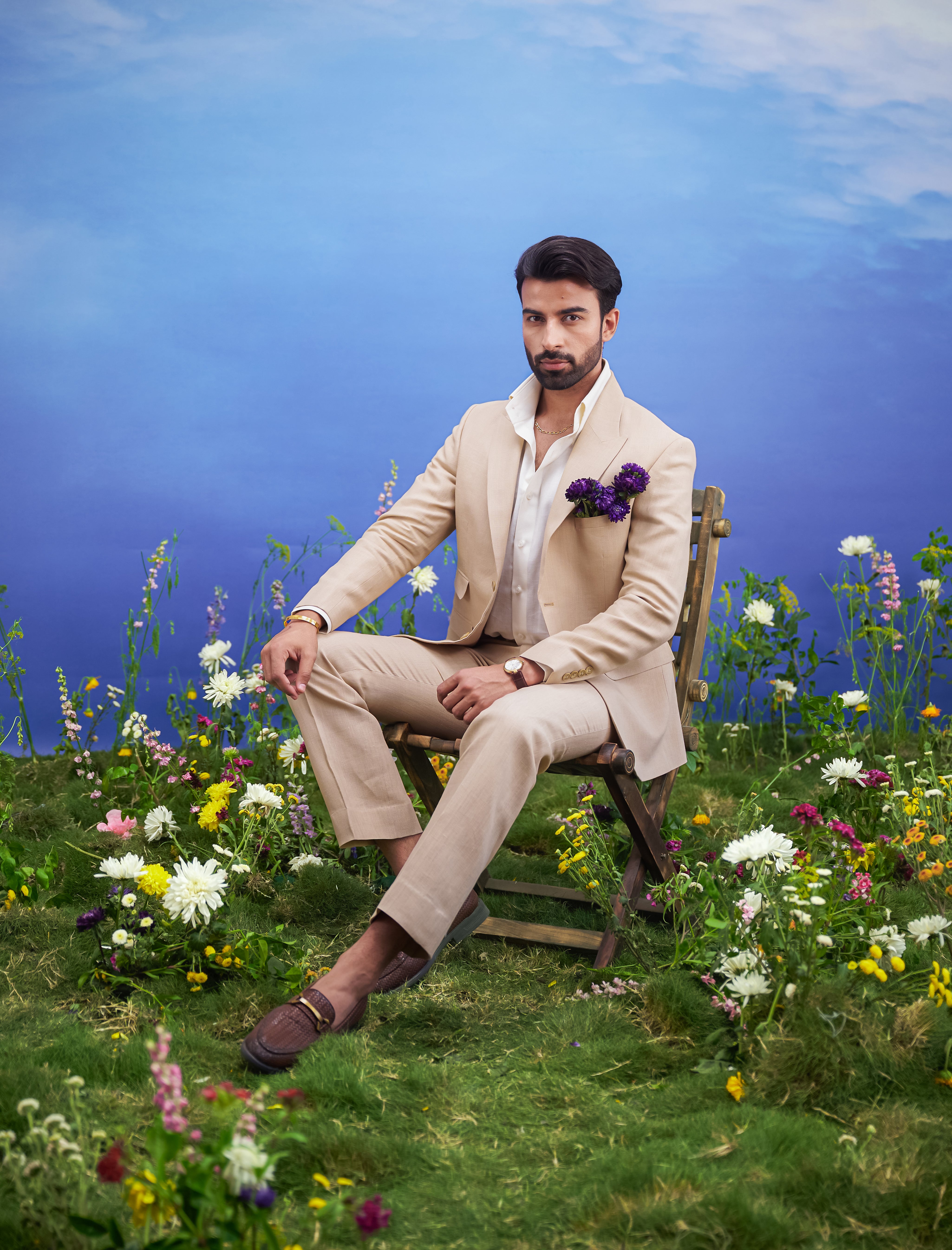 Tan pure linen designer suit, men's formal wear, featuring a linen blazer, trousers, and pocket square.