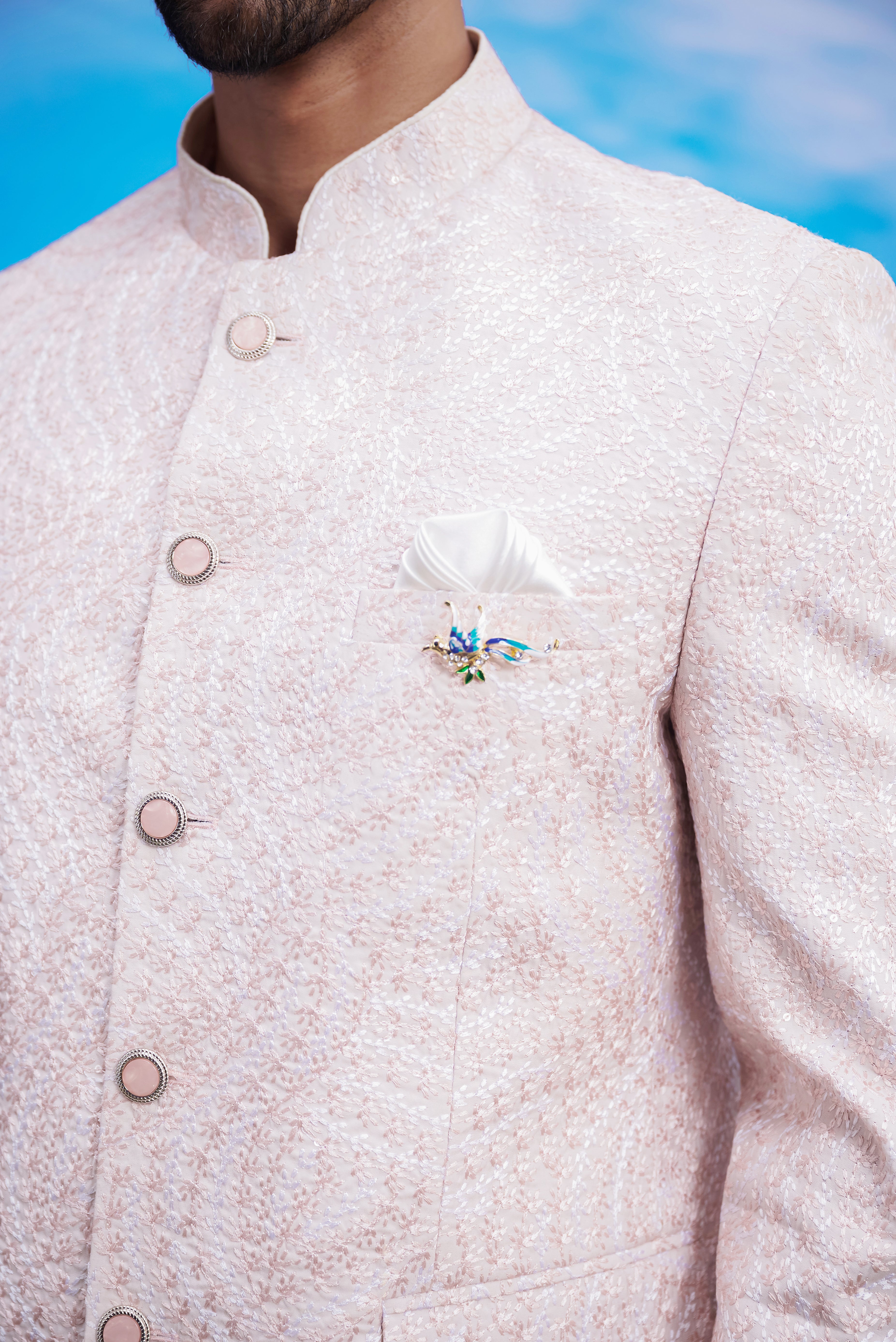 Close-up of the pink embroidered Bandhgala suit, highlighting the embroidery and rayon fabric texture.