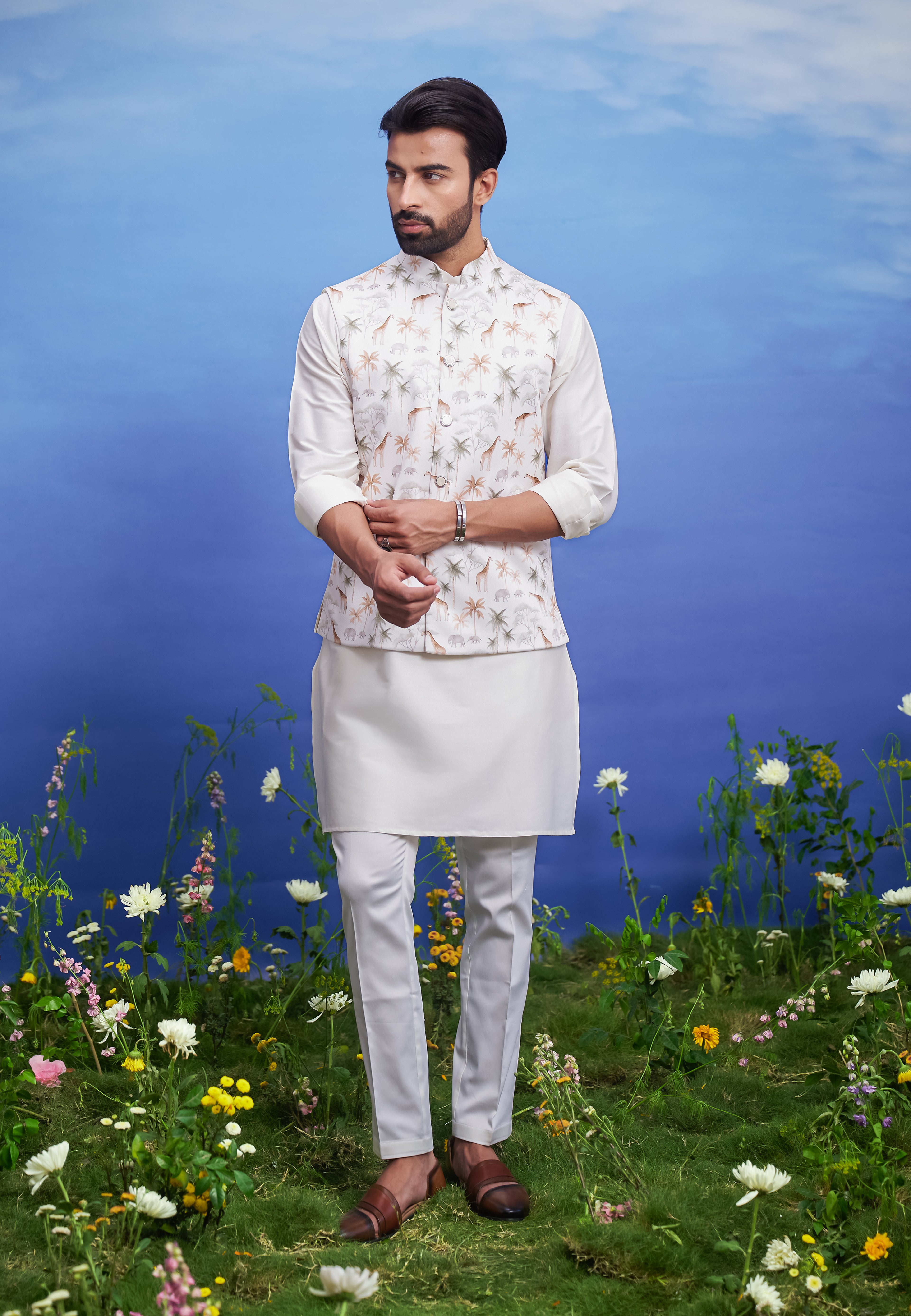 A cream Nehru jacket with an animal motif print, featuring a mandarin collar, ideal for men's party wear.