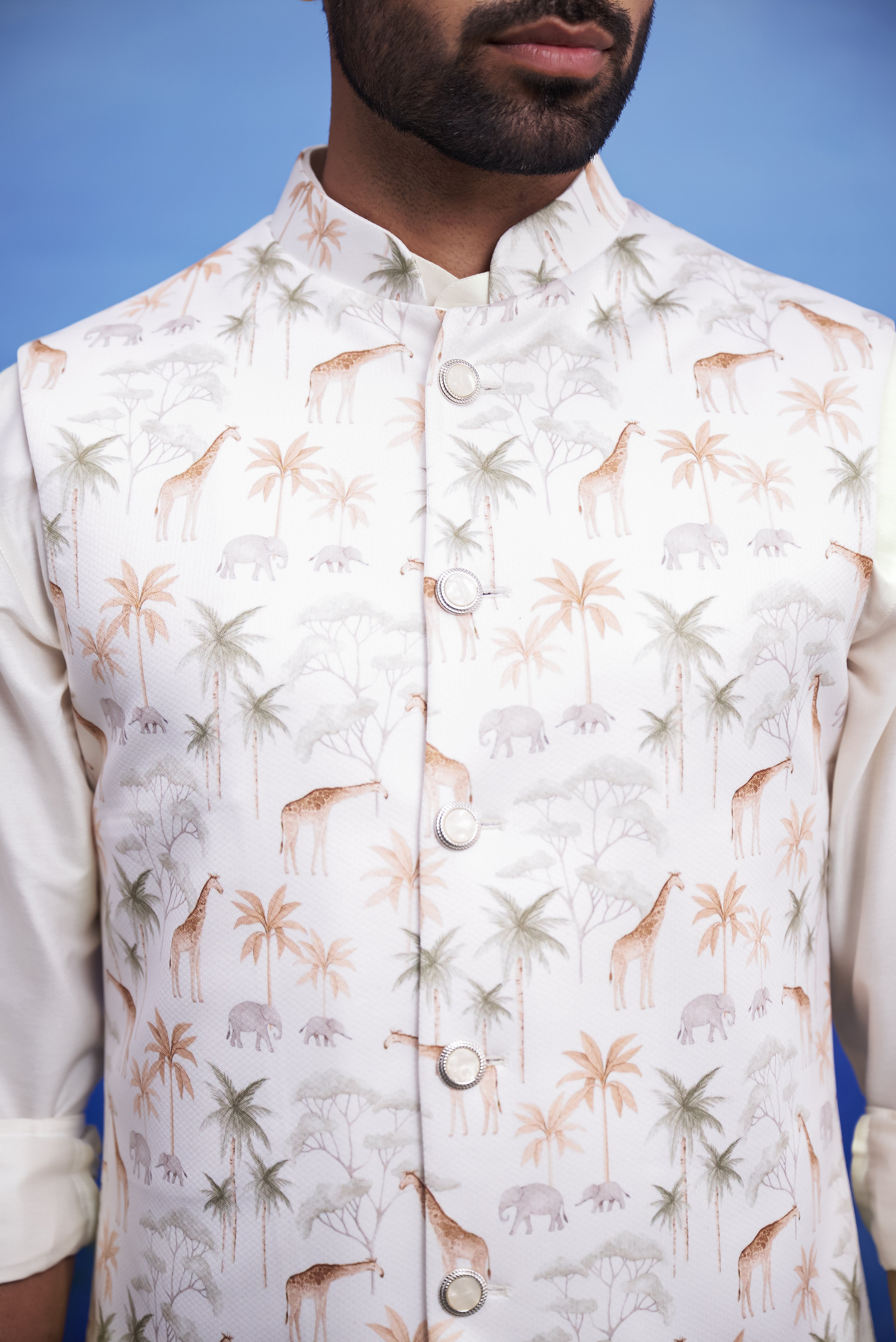 Close-up of the animal motif cream Nehru jacket, highlighting the print and knitted fabric.