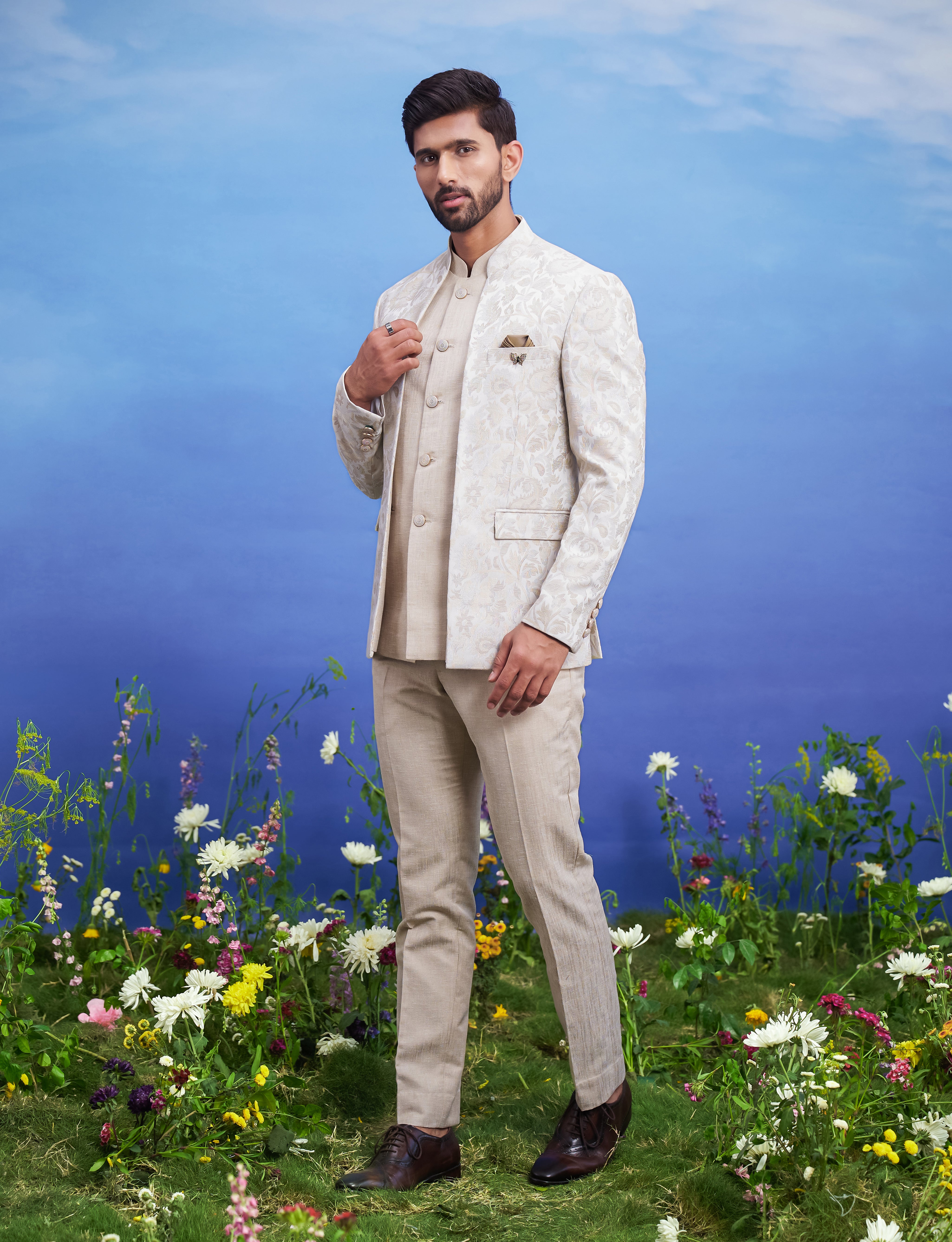 Men's beige jacquard Bandhgala suit with linen jacket, presented as a complete outfit on a product page, designed for festive and wedding events.