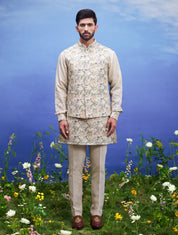 A beige kurta jacket set, featuring a kurta, jacket, and pajama, ideal for men's ethnic wear.