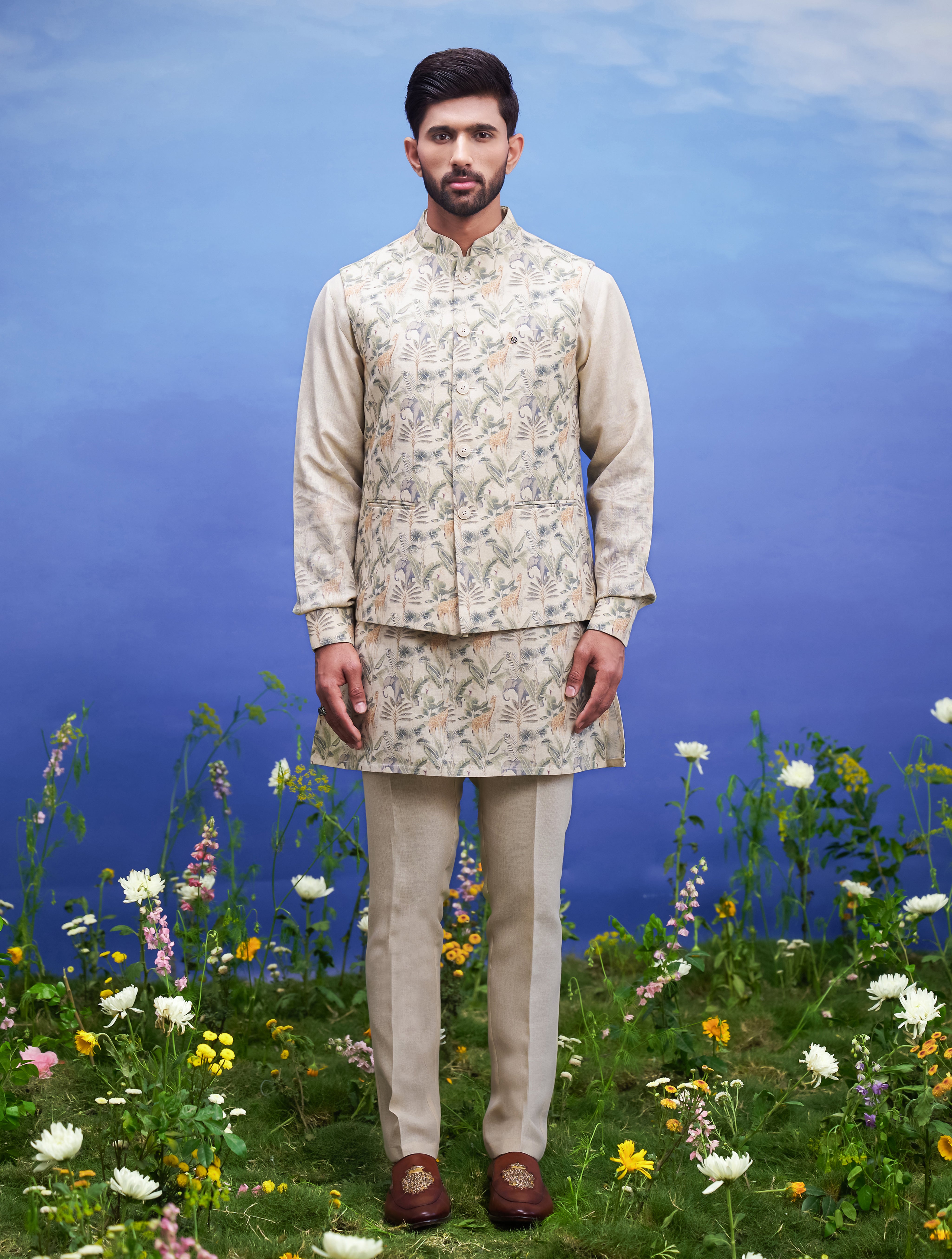 A beige kurta jacket set, featuring a kurta, jacket, and pajama, ideal for men's ethnic wear.