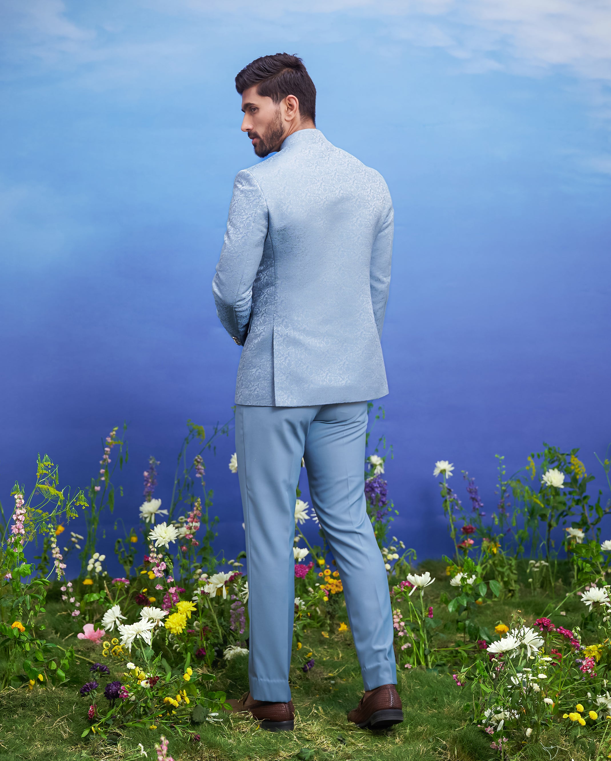 A sophisticated blue Bandhgala suit with a jacquard design, ideal for formal occasions.