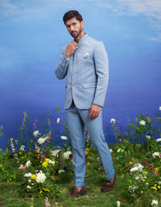 Blue jacquard Bandhgala suit for men, blending traditional elegance with modern styling, suitable for weddings.