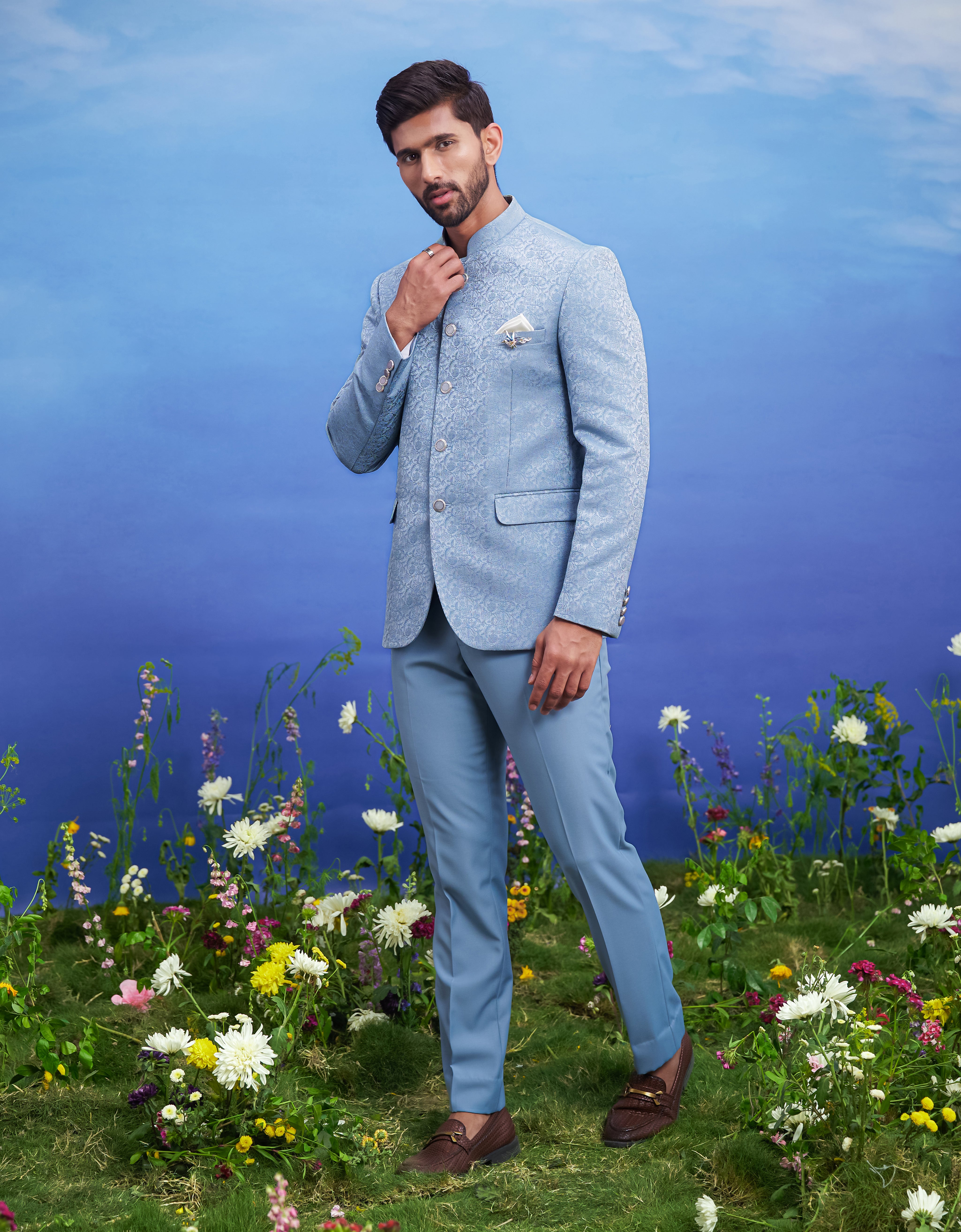 Blue jacquard Bandhgala suit for men, blending traditional elegance with modern styling, suitable for weddings.