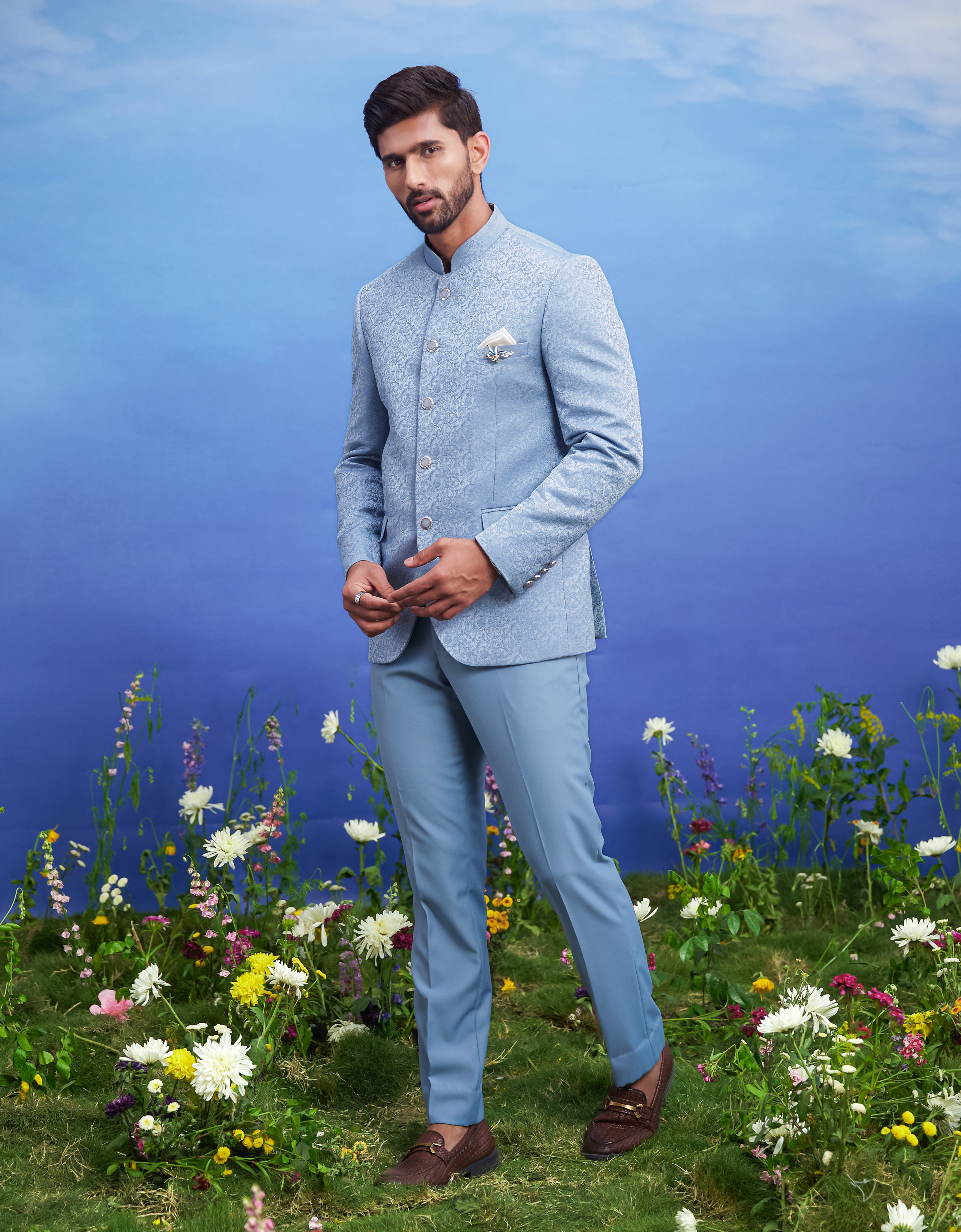 Blue jacquard Bandhgala suit, men's ethnic formal wear, featuring a jacquard Bandhgala, trousers, pocket square, and pin.