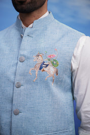 Close-up of the blue Nehru jacket, highlighting the embroidered motif and linen blend fabric.