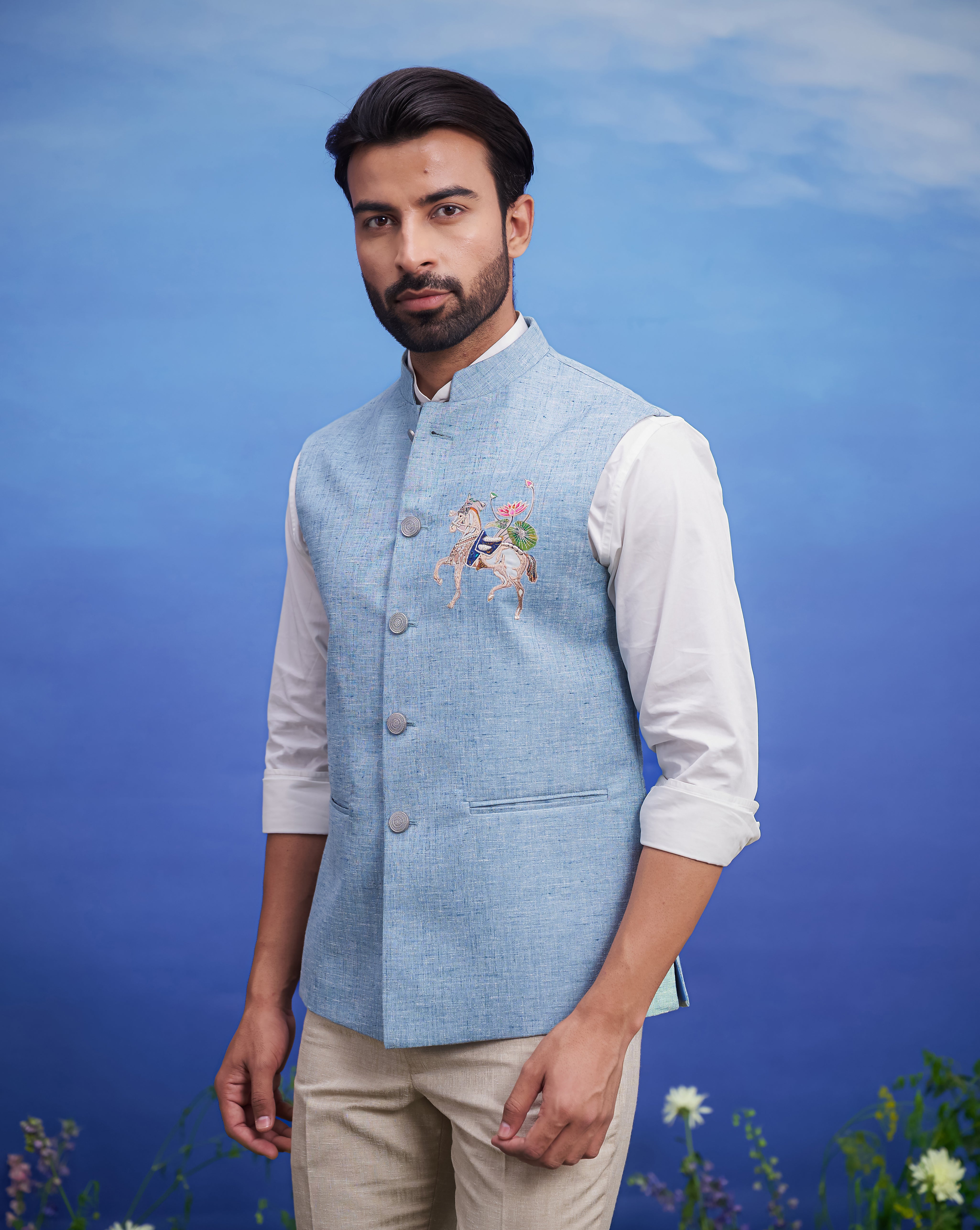 Blue Nehru jacket with embroidered motif for men, made of a linen blend fabric.