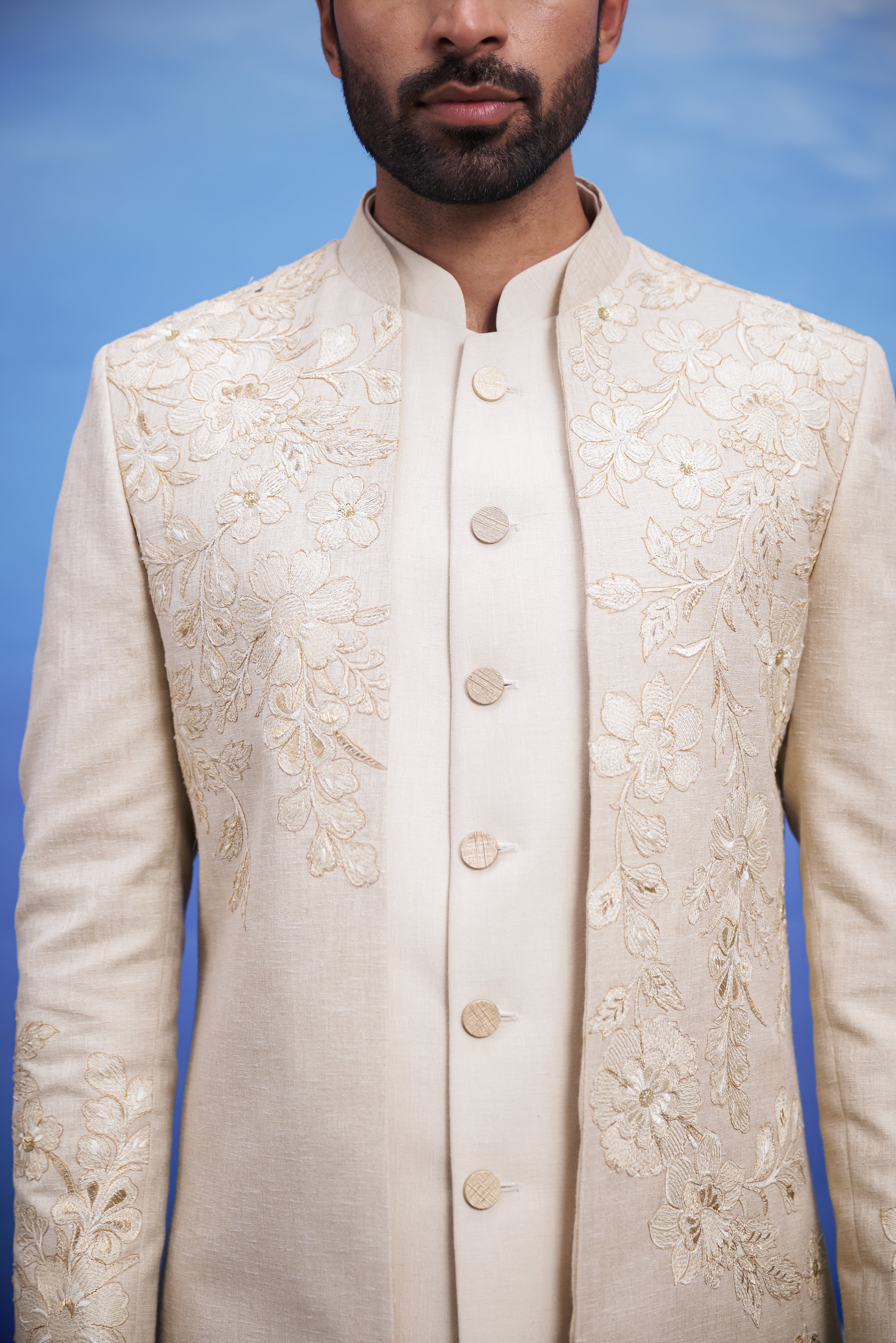Close-up of the cream floral embroidered Indo-western suit, highlighting the floral pattern, zari work, and fabric texture.