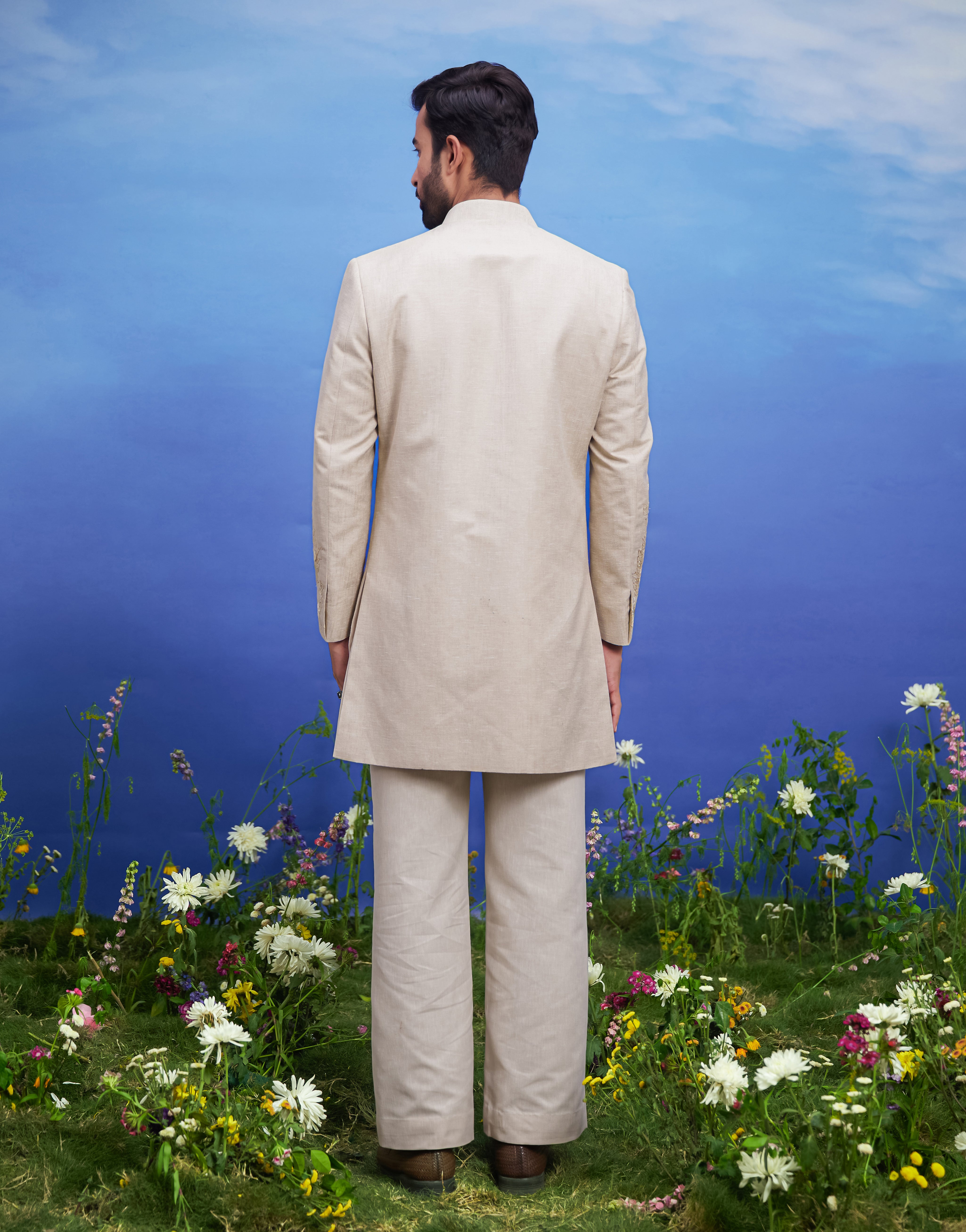 Detailed view of the zari work on a cream floral embroidered Indo-western jacket, showcasing the craftsmanship.