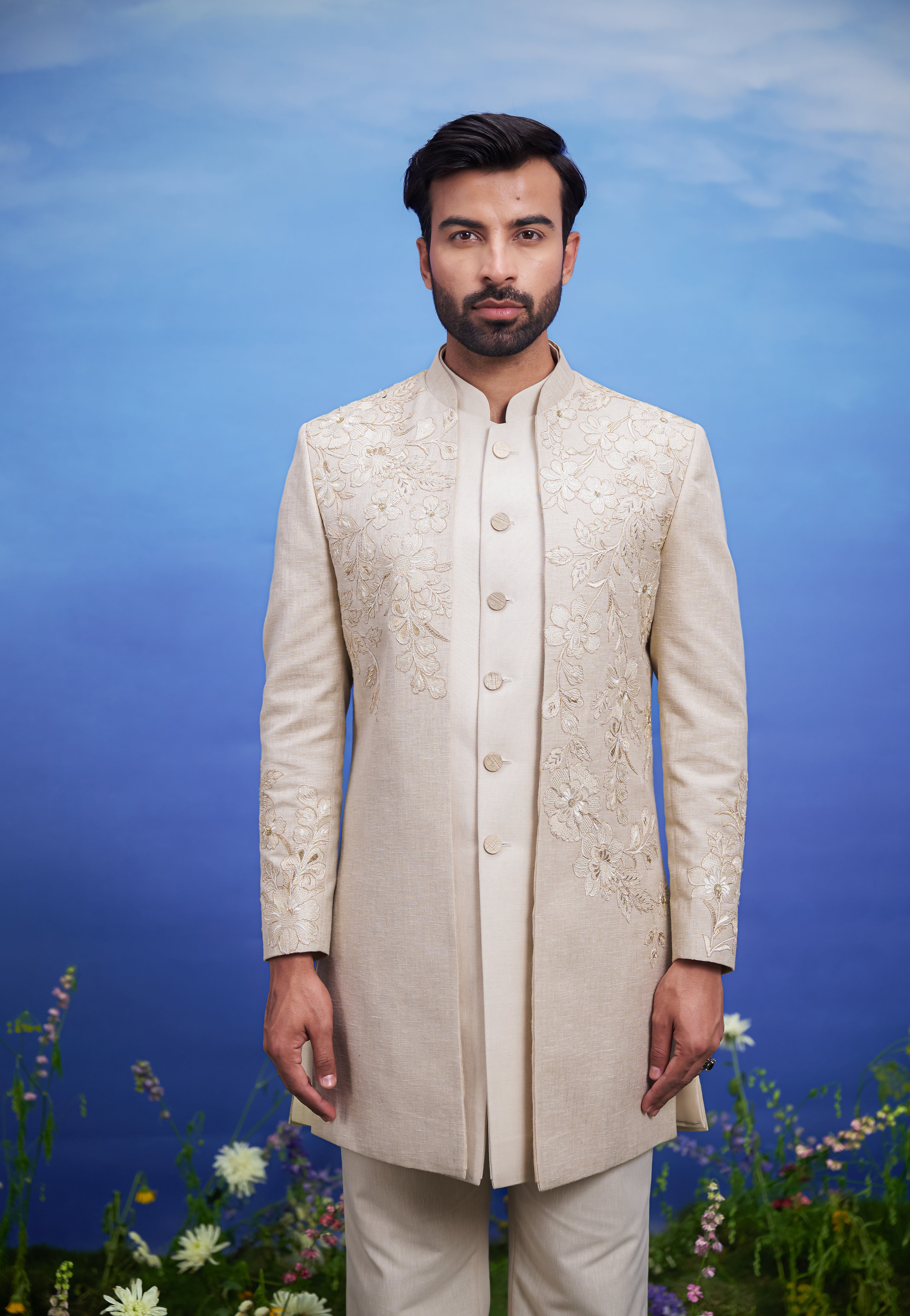 Men's cream floral embroidered Indo-western suit with zari, presented as a complete outfit on a product page, designed for festive and wedding events.