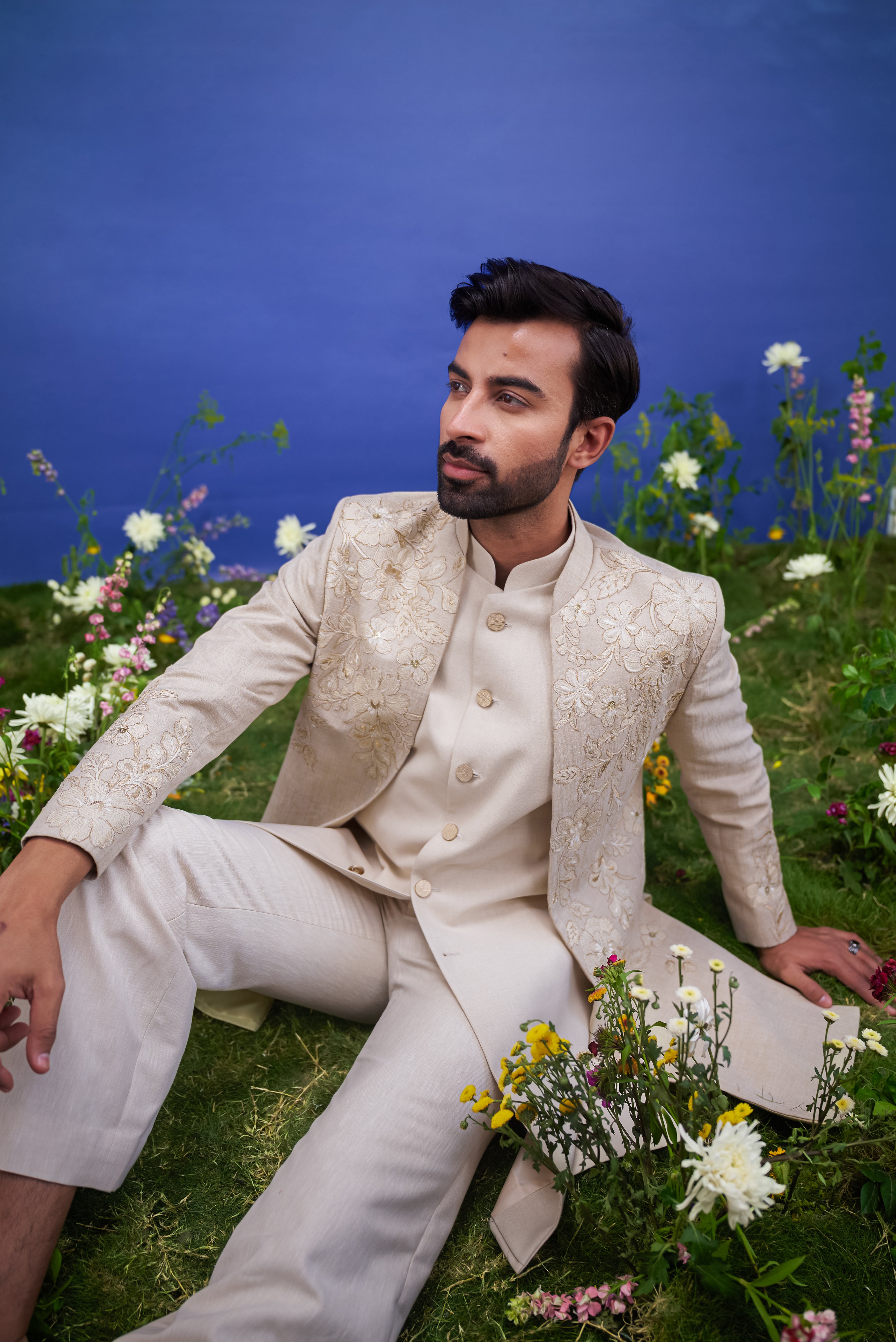 A detailed view of the cream floral embroidered Indo-western suit, showcasing the floral pattern, zari work, and fabric quality.