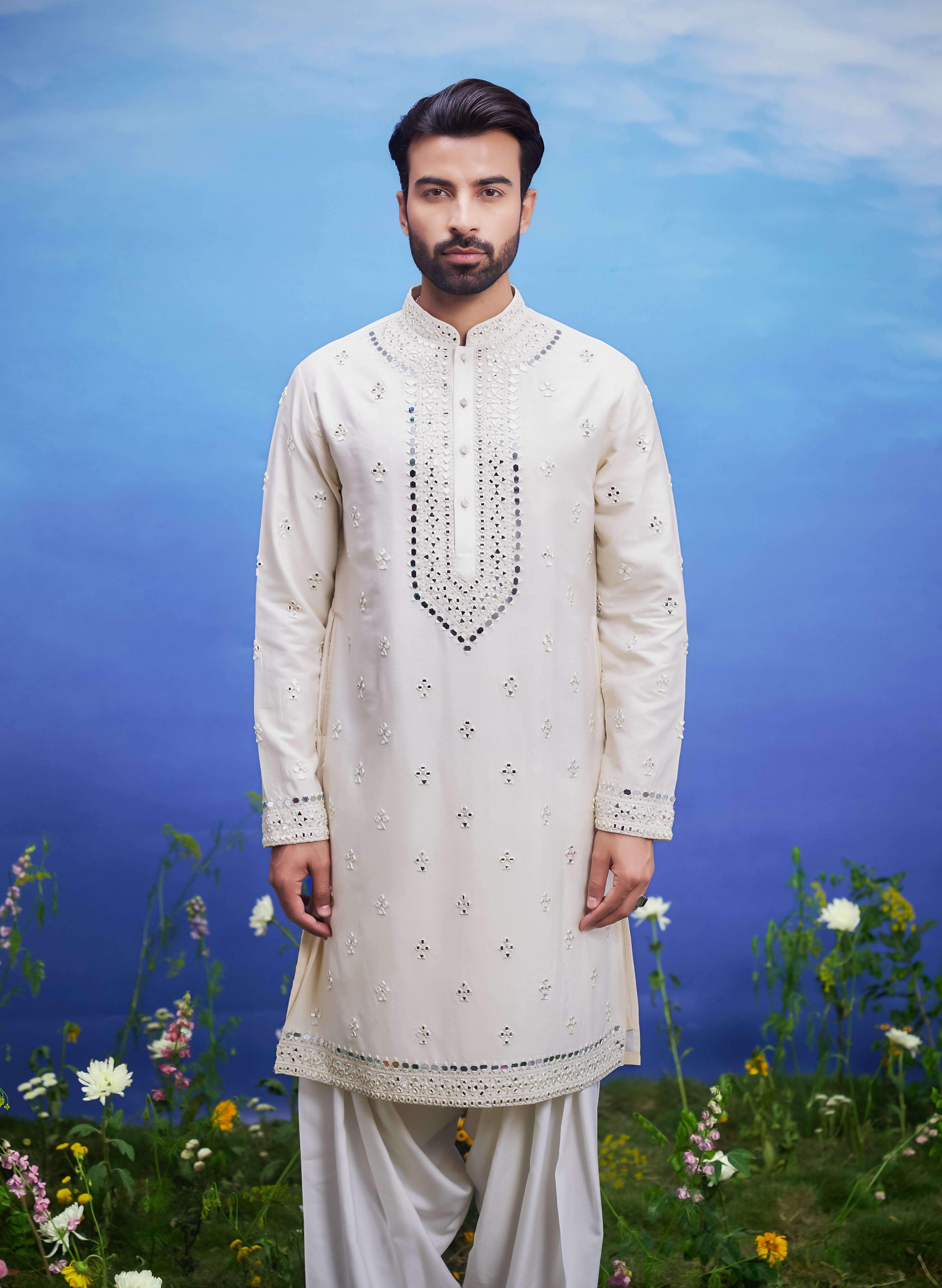 A cream kurta set with mirror work embroidery, featuring a kurta and Patiala salwar, ideal for men's ethnic wear.