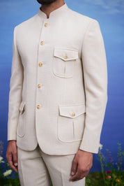 Close-up of the cream patch pocket Bandhgala suit, highlighting the patch pocket design and textured fabric.
