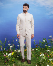 Cream patch pocket Bandhgala suit for men, blending traditional elegance with modern patch pocket styling, suitable for weddings.