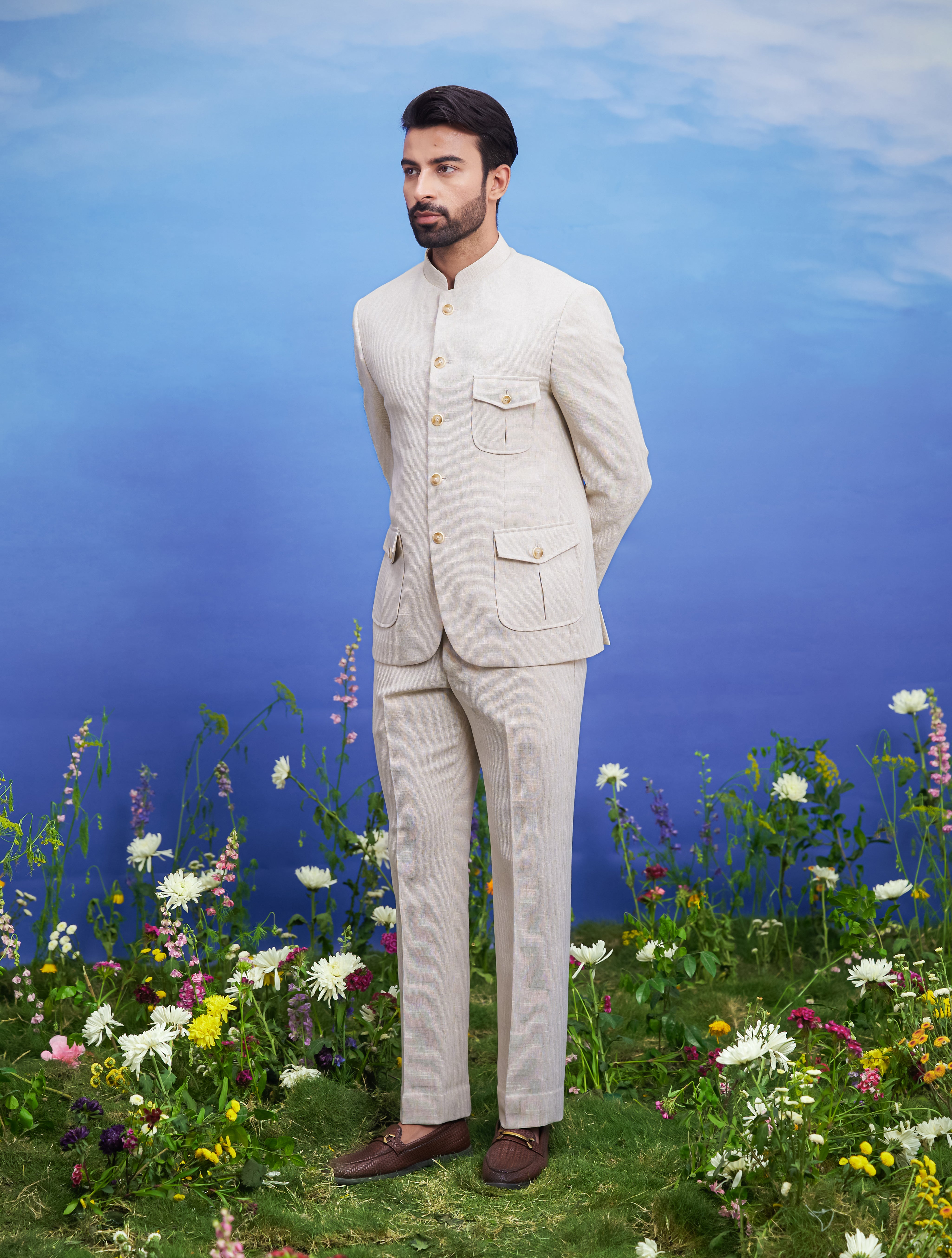 A sophisticated cream Bandhgala suit with distinct patch pockets, ideal for formal occasions.