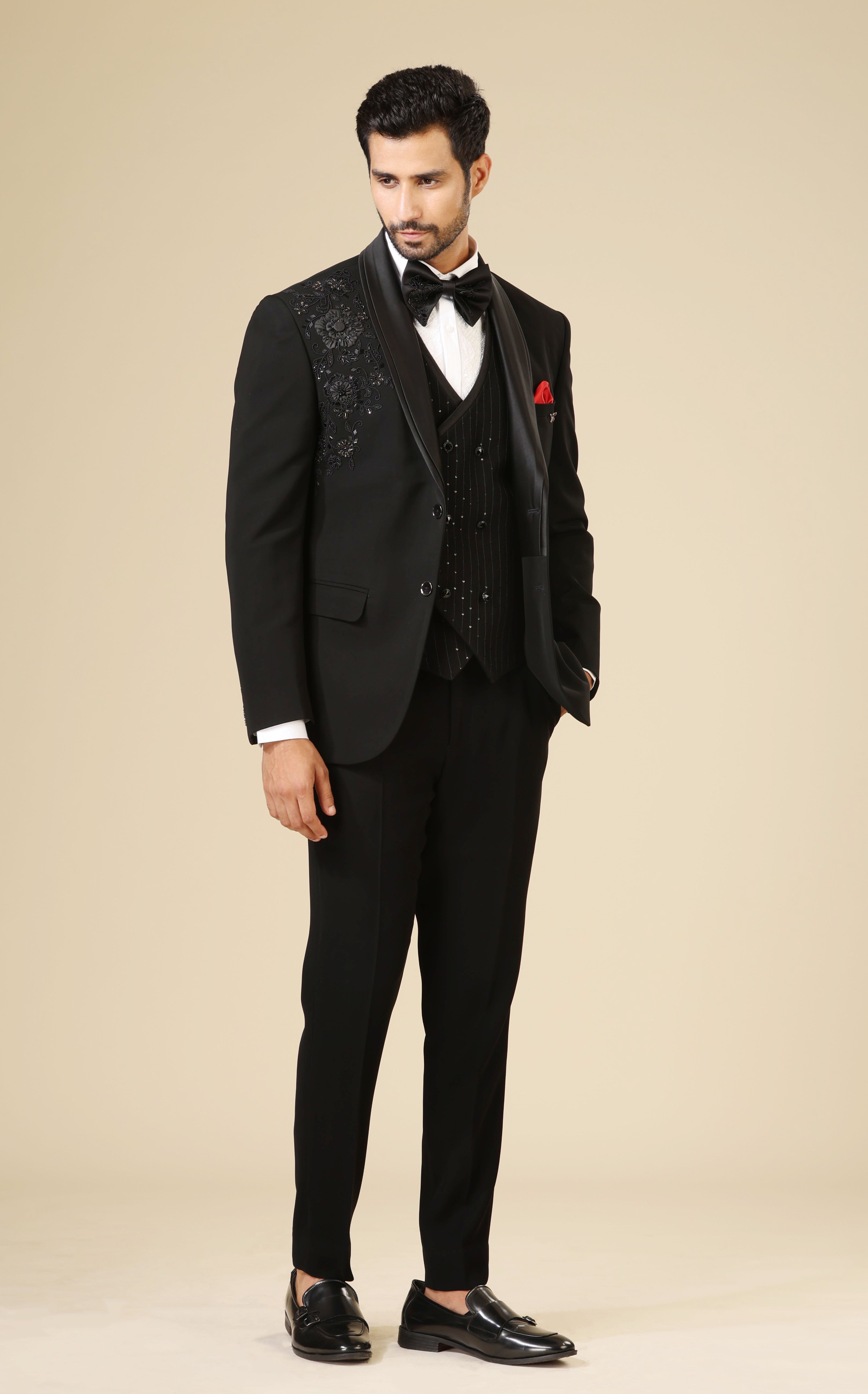 An elegant black embroidered tuxedo suit, modern men's fashion.
