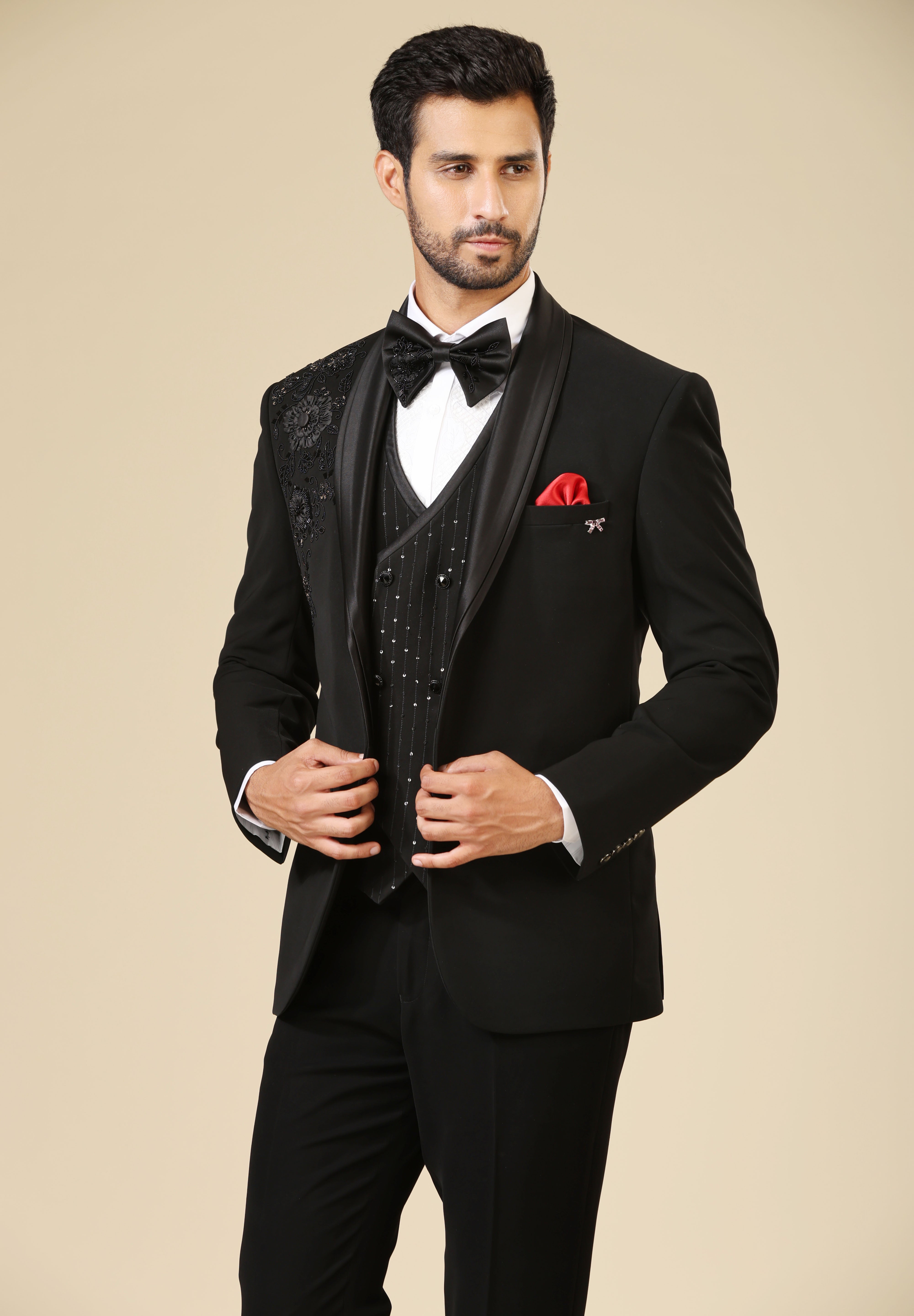 A luxurious black embroidered tuxedo suit with double-breasted vest, a timeless classic.
