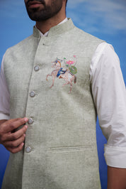 Close-up of the green Nehru jacket, highlighting the embroidered motif and linen blend fabric.