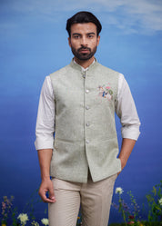 Men's green Nehru jacket with an embroidered motif, displayed on a product page with size options.