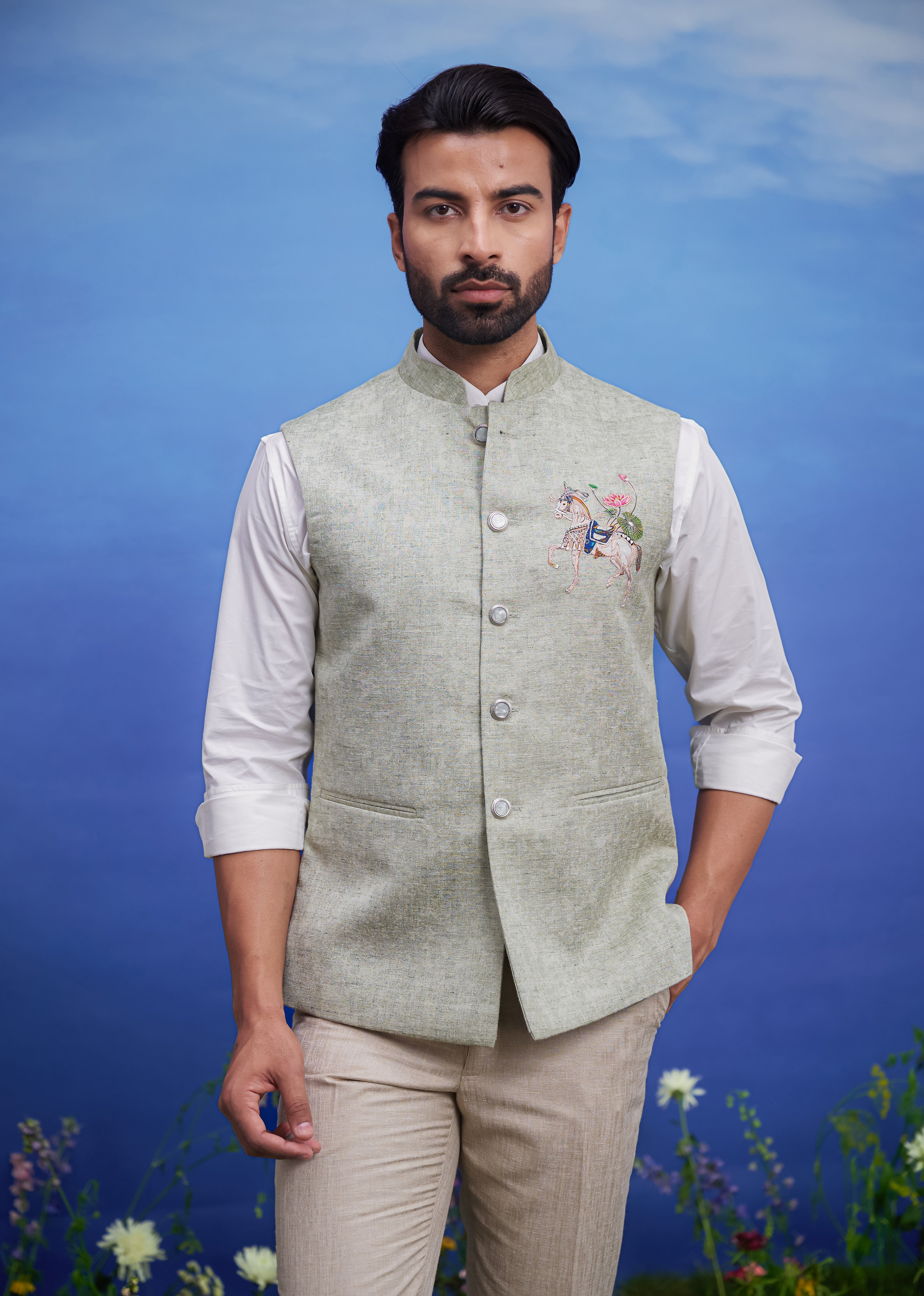 Men's green Nehru jacket with an embroidered motif, displayed on a product page with size options.