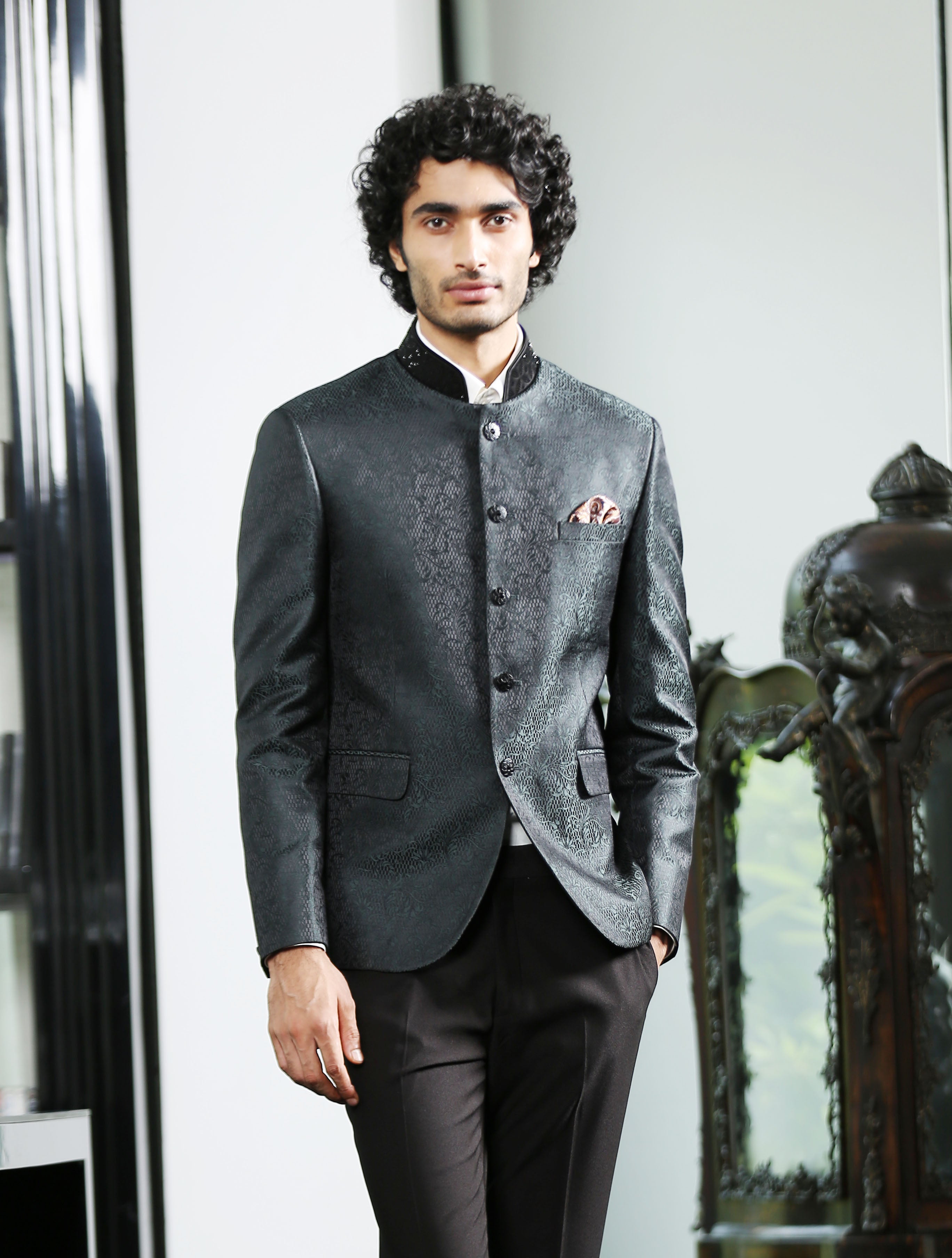 A stylish green bandhgala with crystal work, perfect for weddings and formal occasions.
