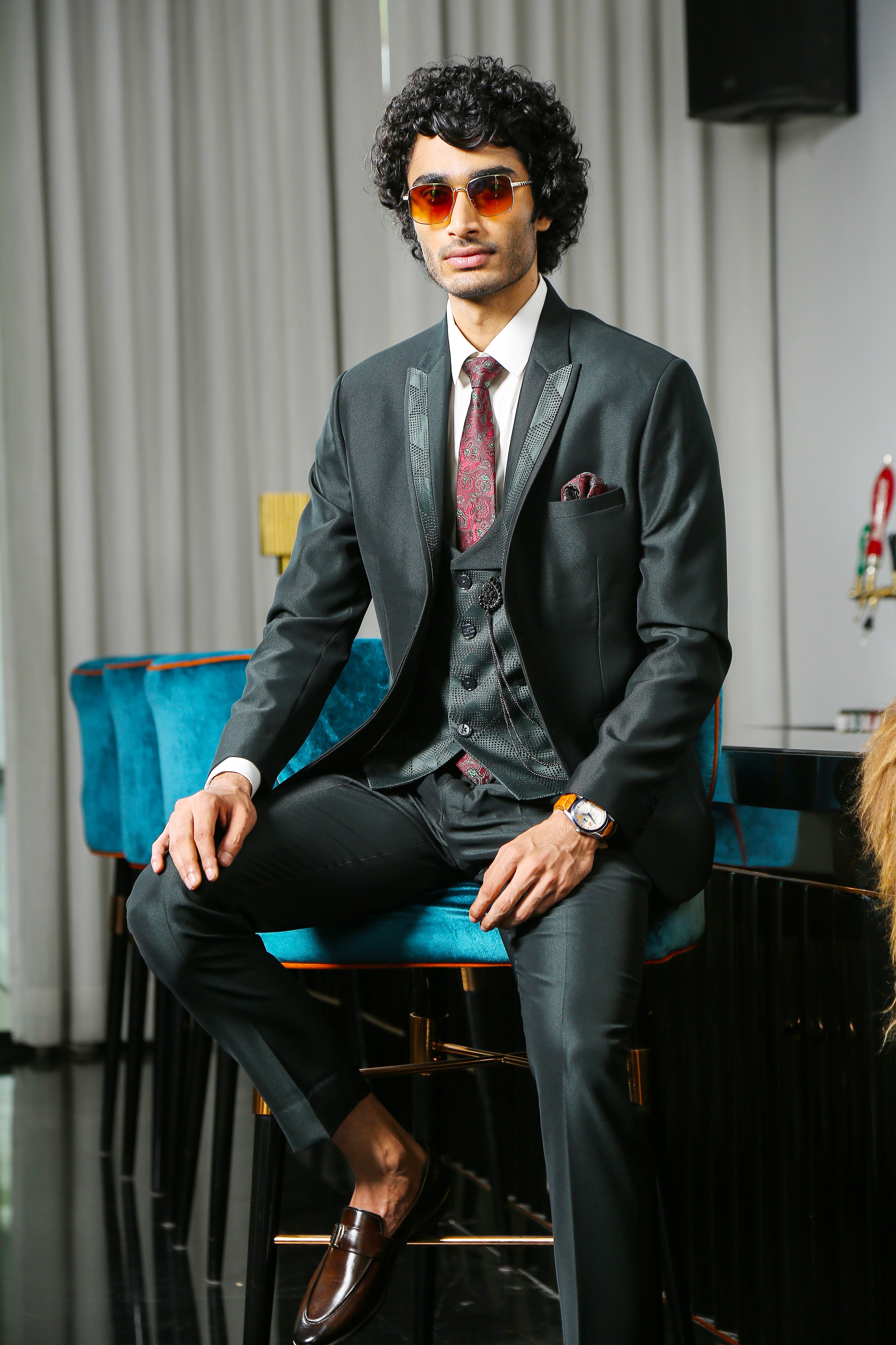 A stylish green suit with designer vest, perfect for weddings and formal occasions.
