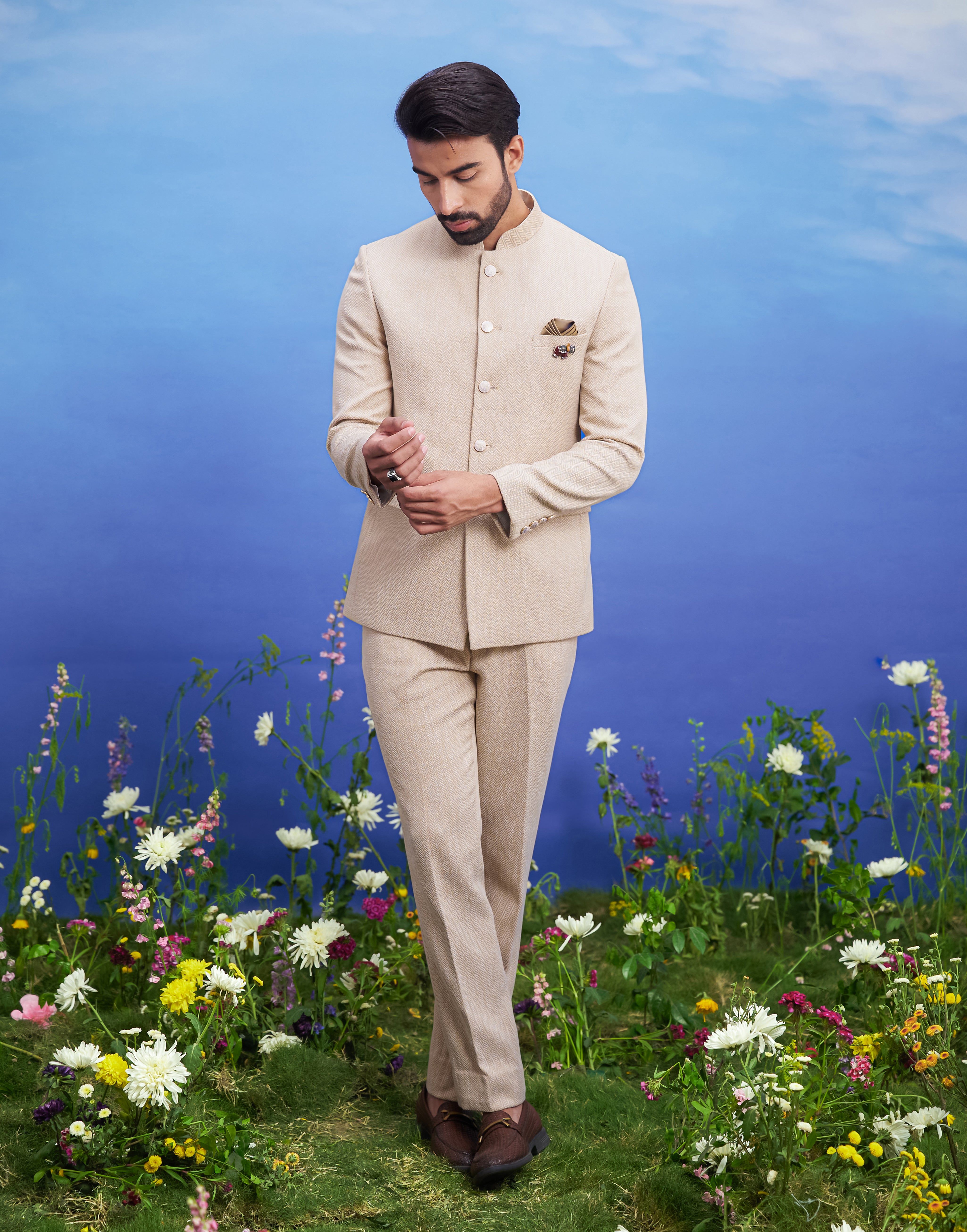 Beige Herringbone structured Bandhgala suit, men's ethnic formal wear, featuring a tailored Bandhgala, trousers, pocket square, and pin.