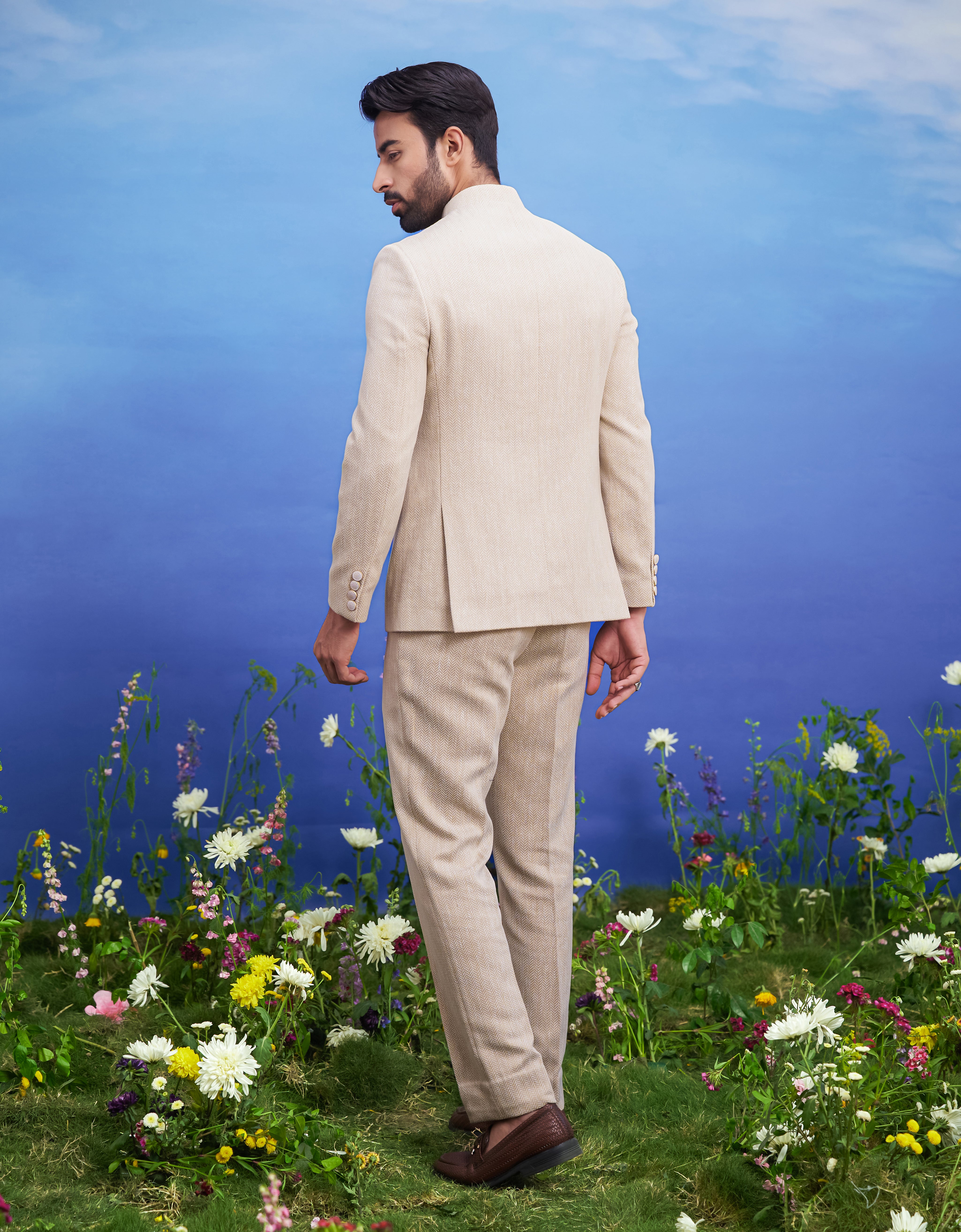 Men's beige Herringbone structured Bandhgala suit, presented as a complete outfit on a product page, designed for festive and wedding events.