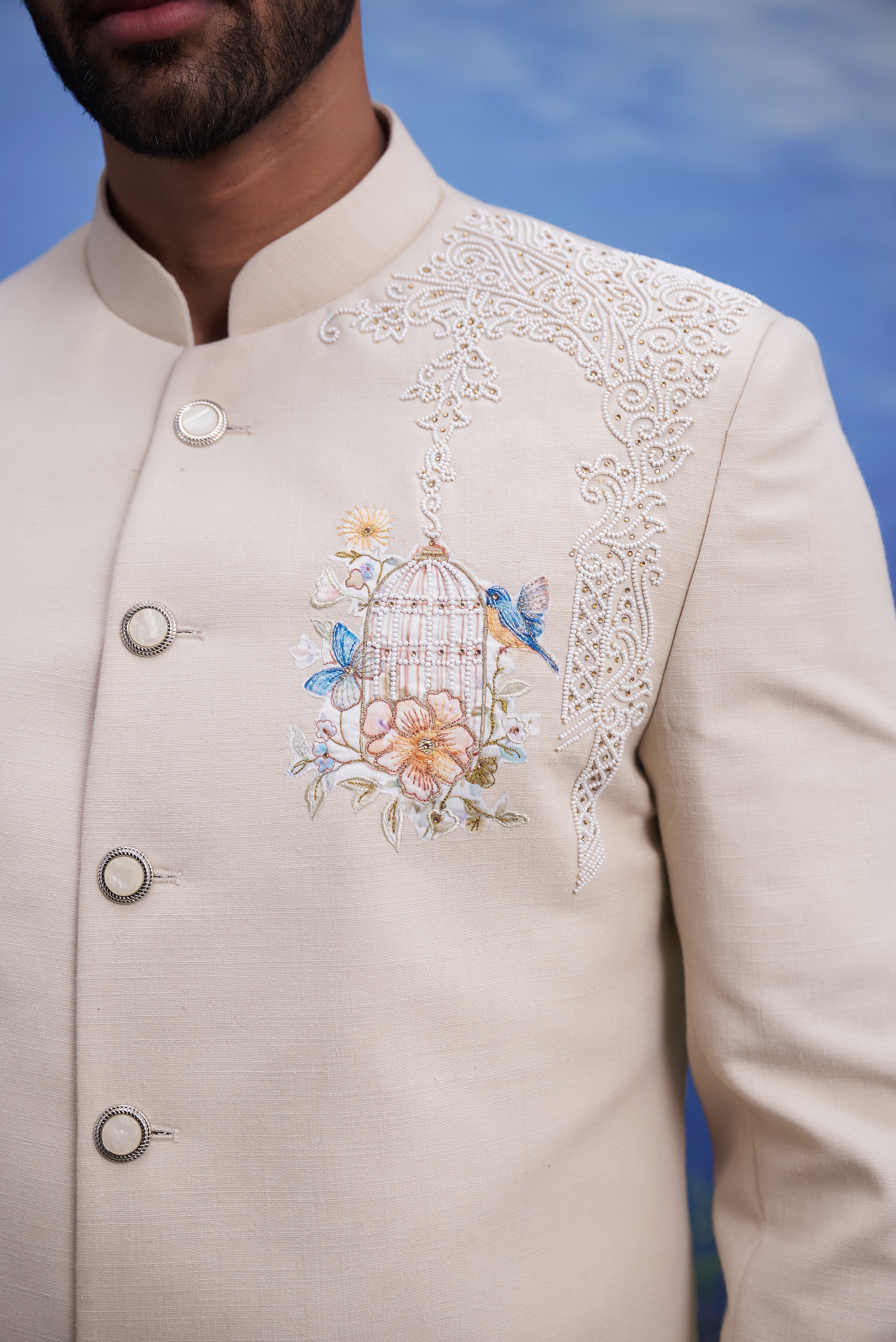 Close-up of the beige Indo-Western suit, highlighting the embroidered motif and linen blend fabric texture.