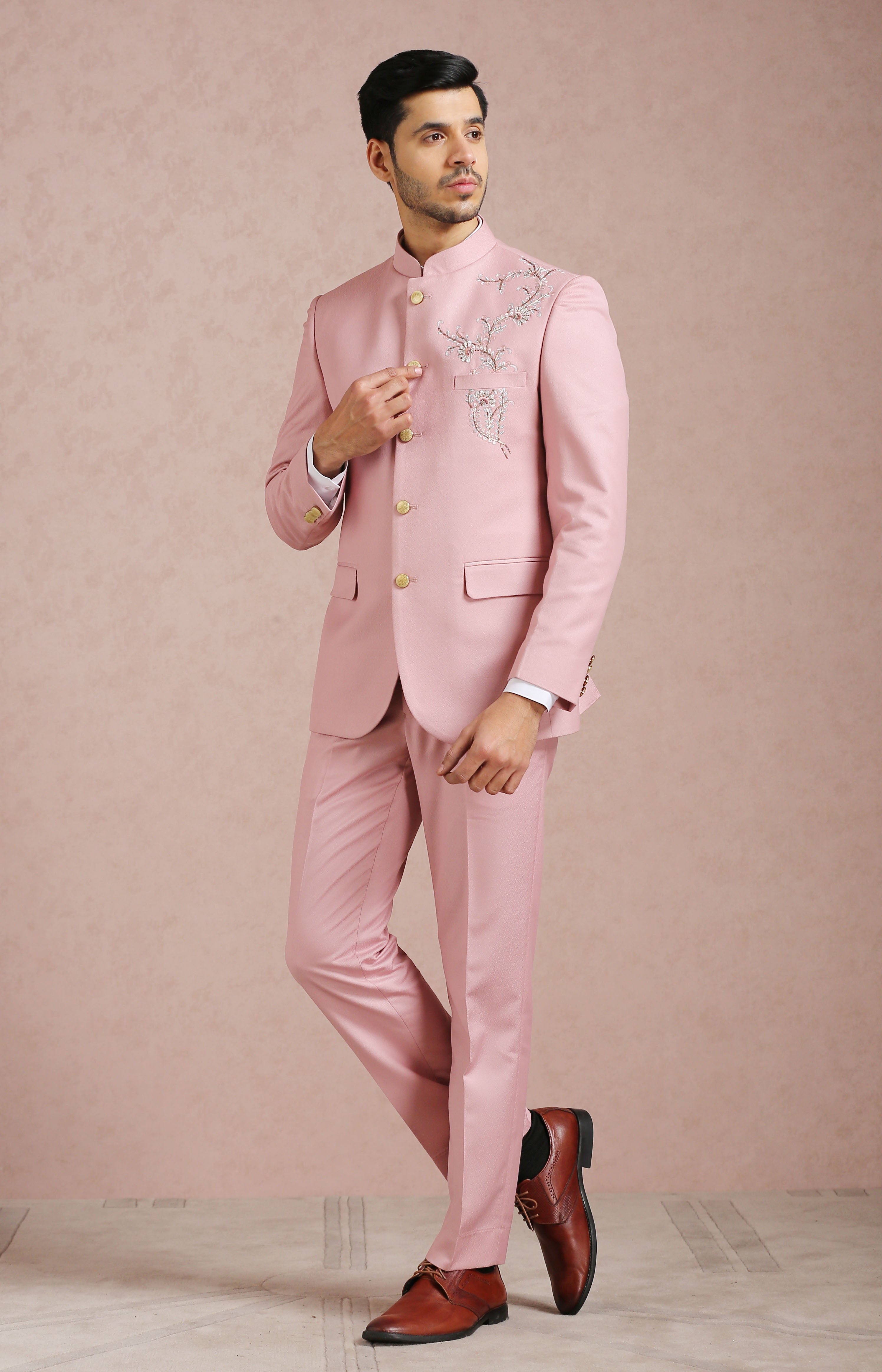 A luxurious light pink bandhgala with embroidered motif, perfect for special occasions.

