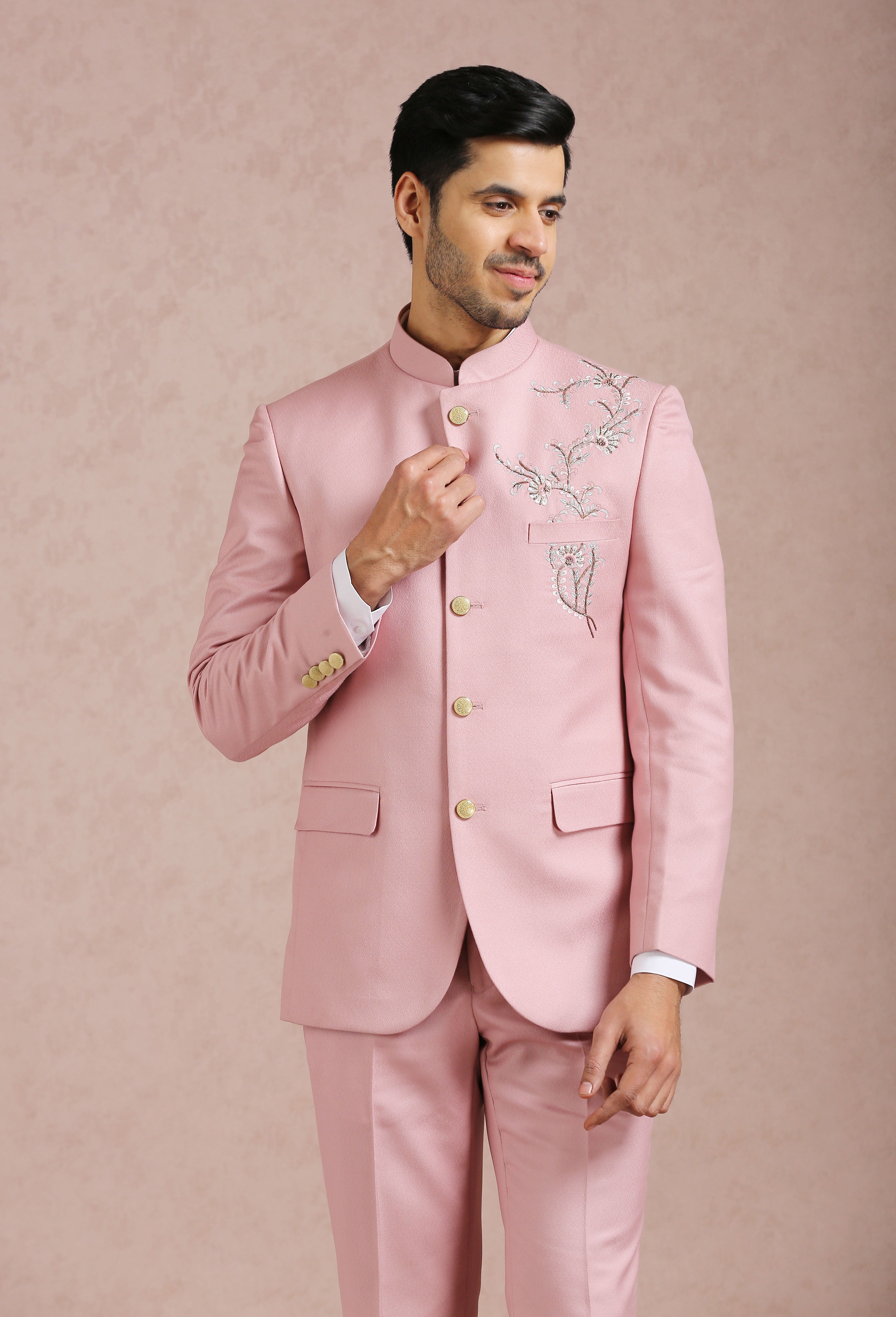 A stylish light pink bandhgala with embroidered motif, perfect for weddings and formal occasions.
