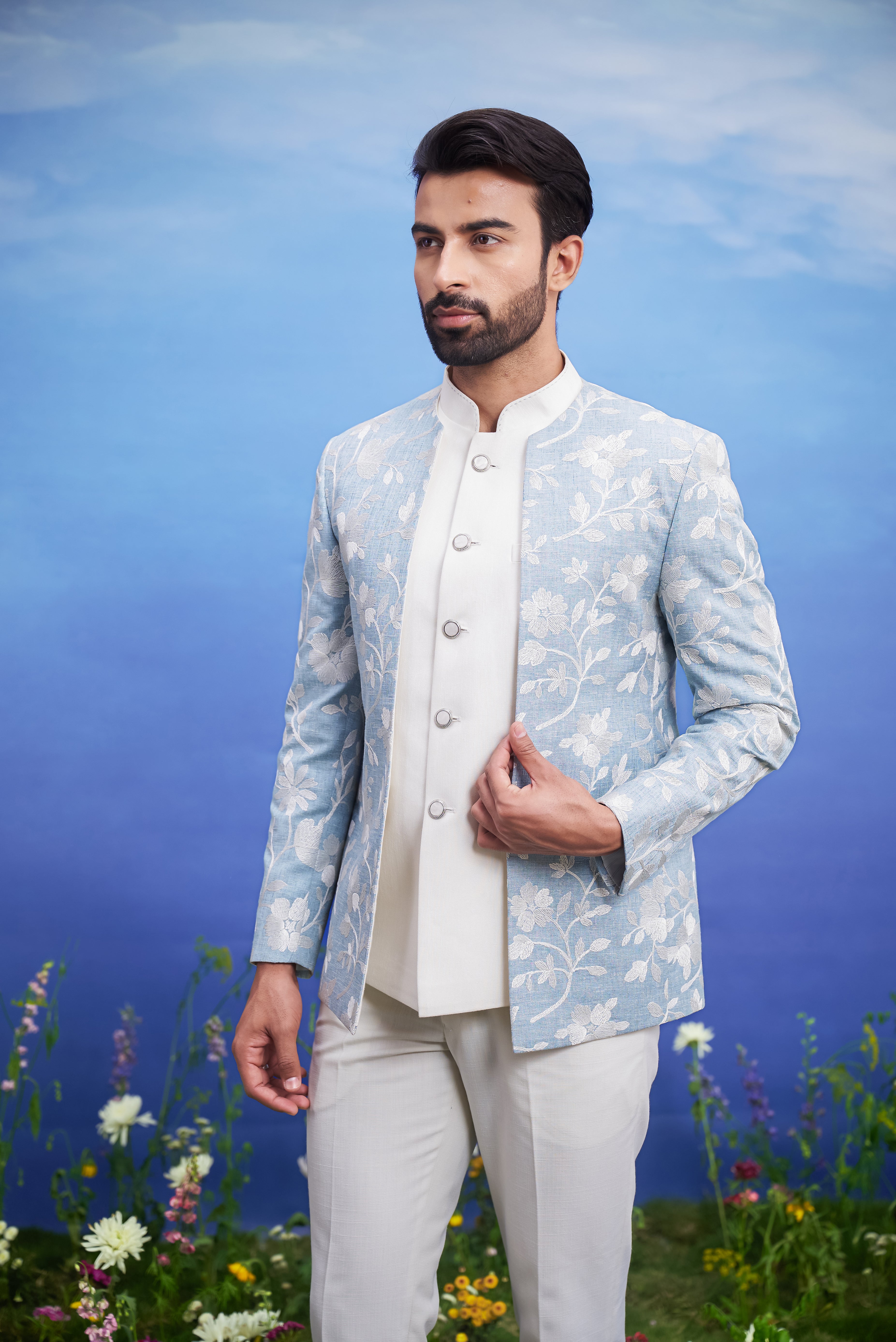 A sophisticated light blue Bandhgala suit with an open front and linen blend fabric, ideal for formal occasions.