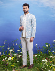 Men's light blue linen open Bandhgala suit featuring a linen blend Bandhgala, sleeveless jacket, mid-rise trousers, and pin.