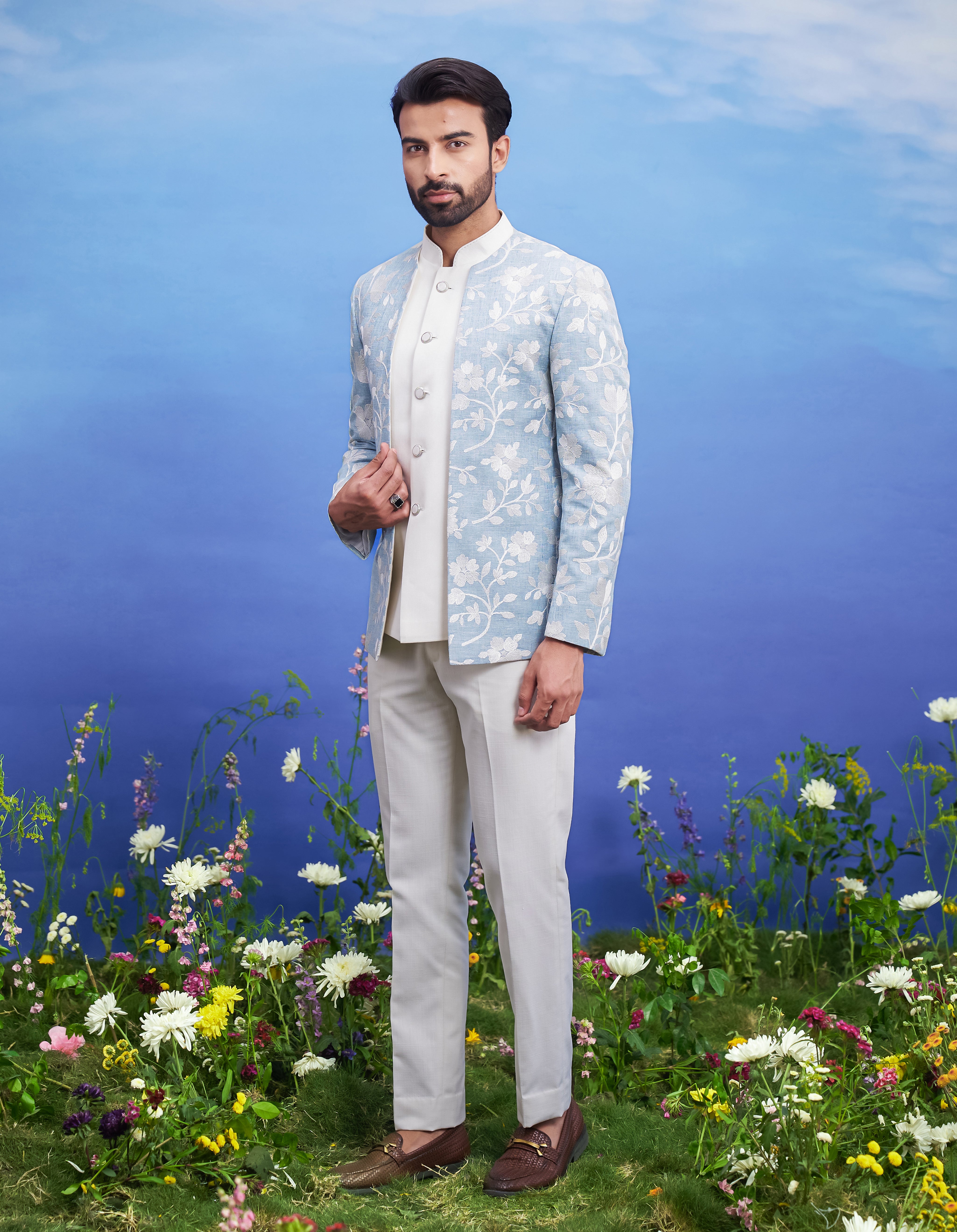 Men's light blue linen open Bandhgala suit featuring a linen blend Bandhgala, sleeveless jacket, mid-rise trousers, and pin.
