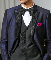 A stylish navy blue jacquard designer suit with intricate embroidery, perfect for weddings and formal occasions.
