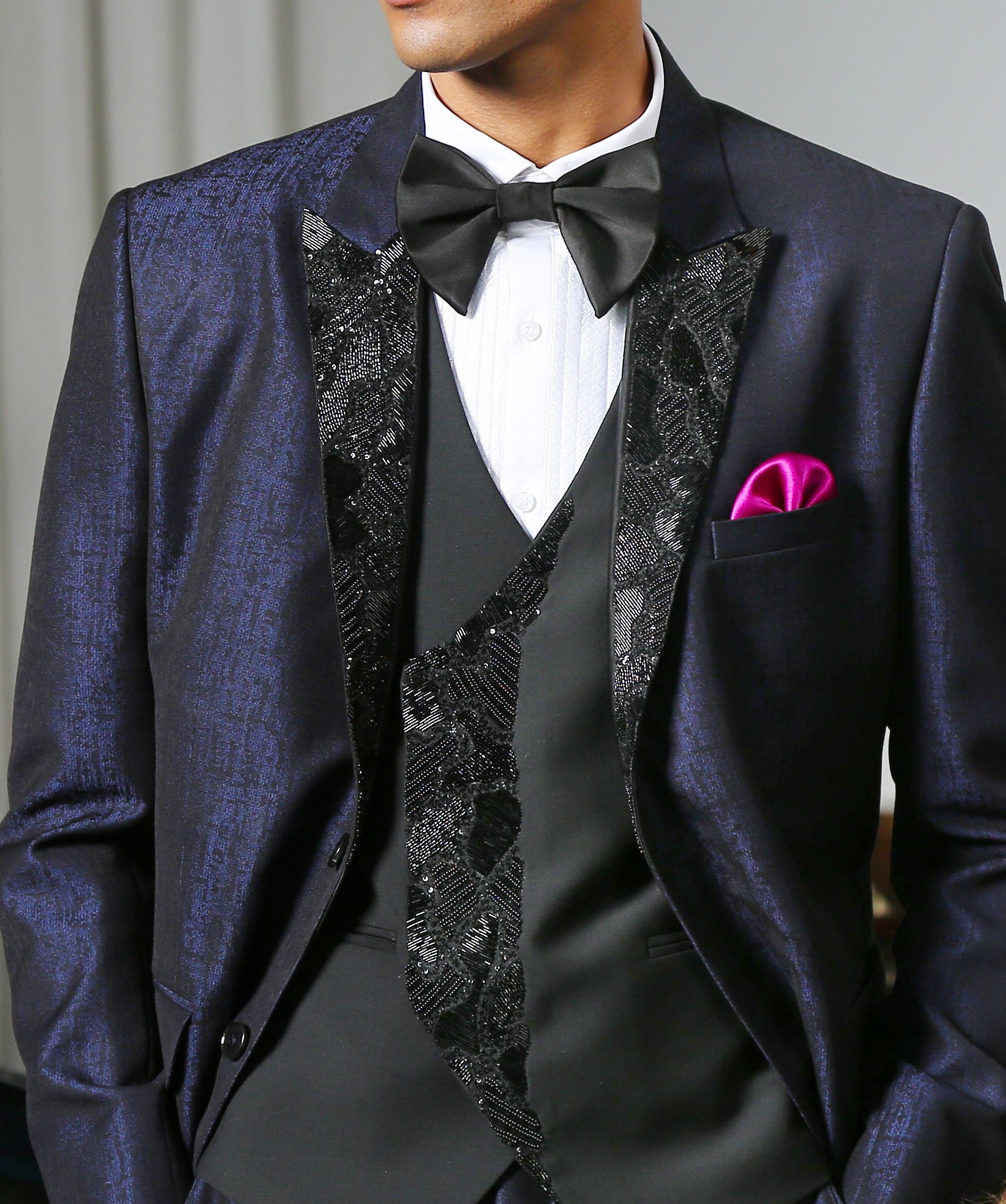 A stylish navy blue jacquard designer suit with intricate embroidery, perfect for weddings and formal occasions.
