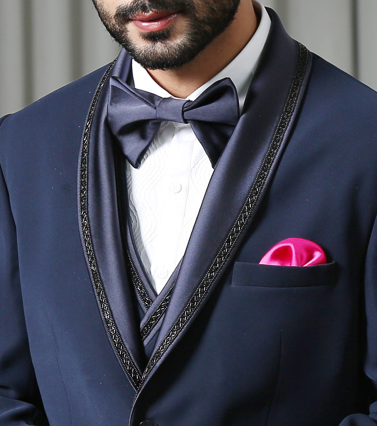 A stylish navy blue designer suit, perfect for weddings and formal occasions.
