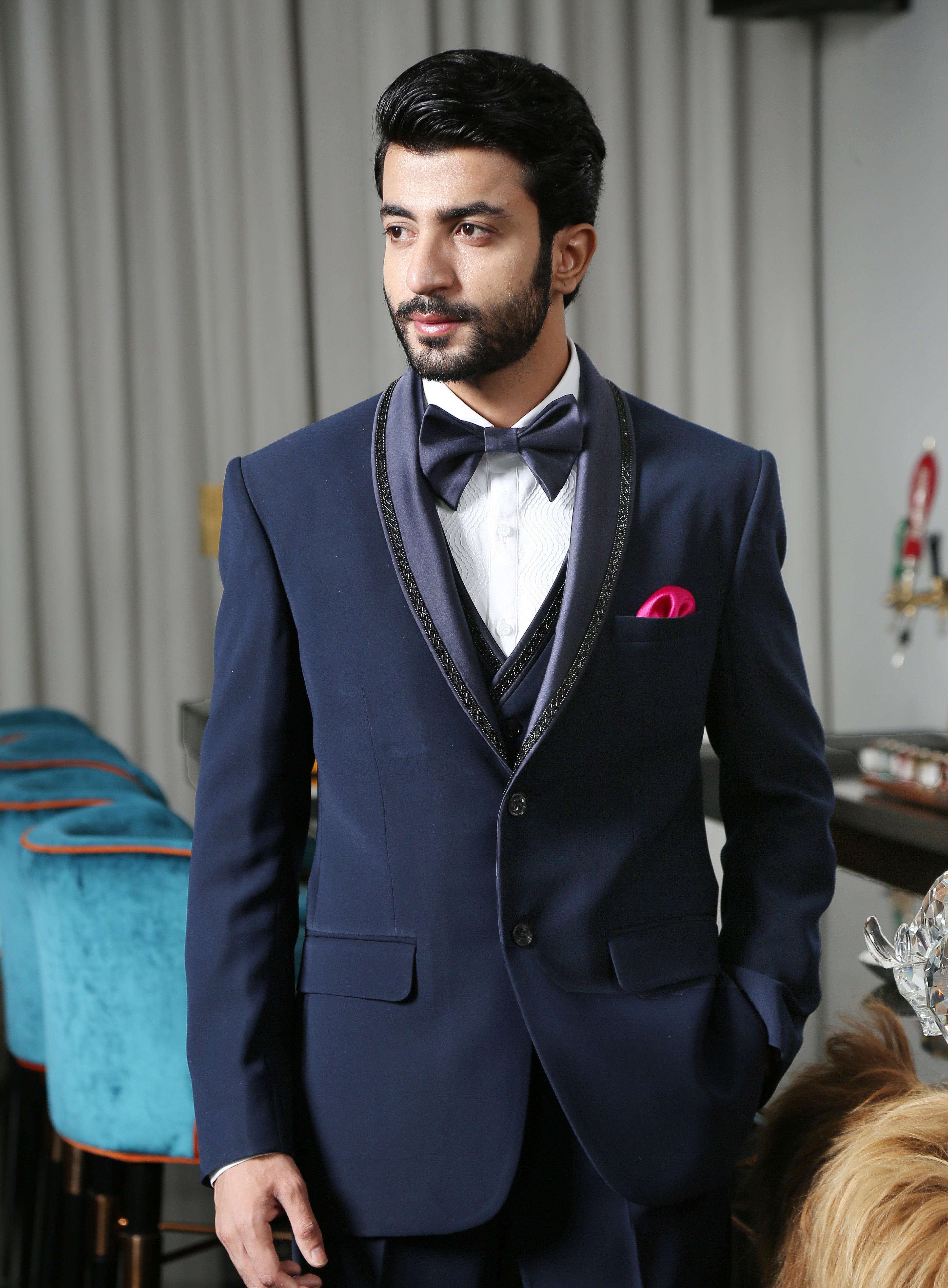 A trendy navy blue designer suit with embroidery, urban style.
