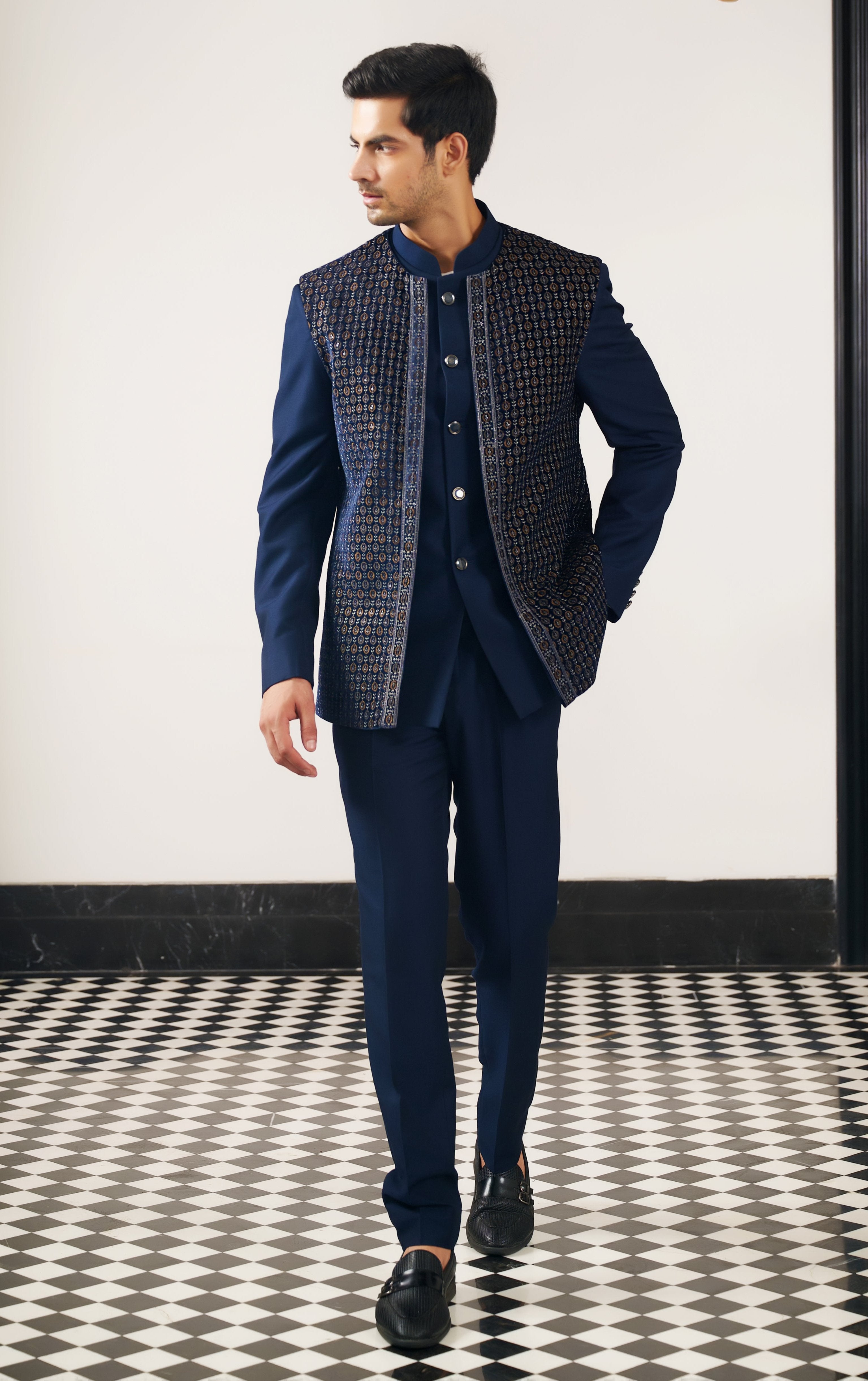 A regal navy blue embroidered open jacket bandhgala, a majestic ensemble.
