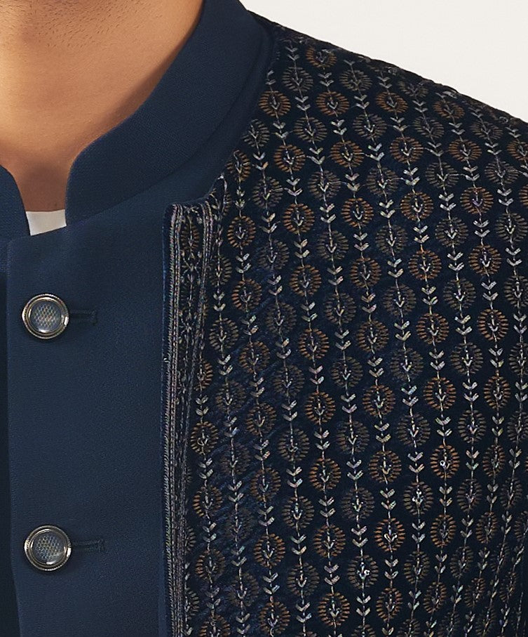 An elegant navy blue embroidered open jacket bandhgala, traditional Indian attire.
