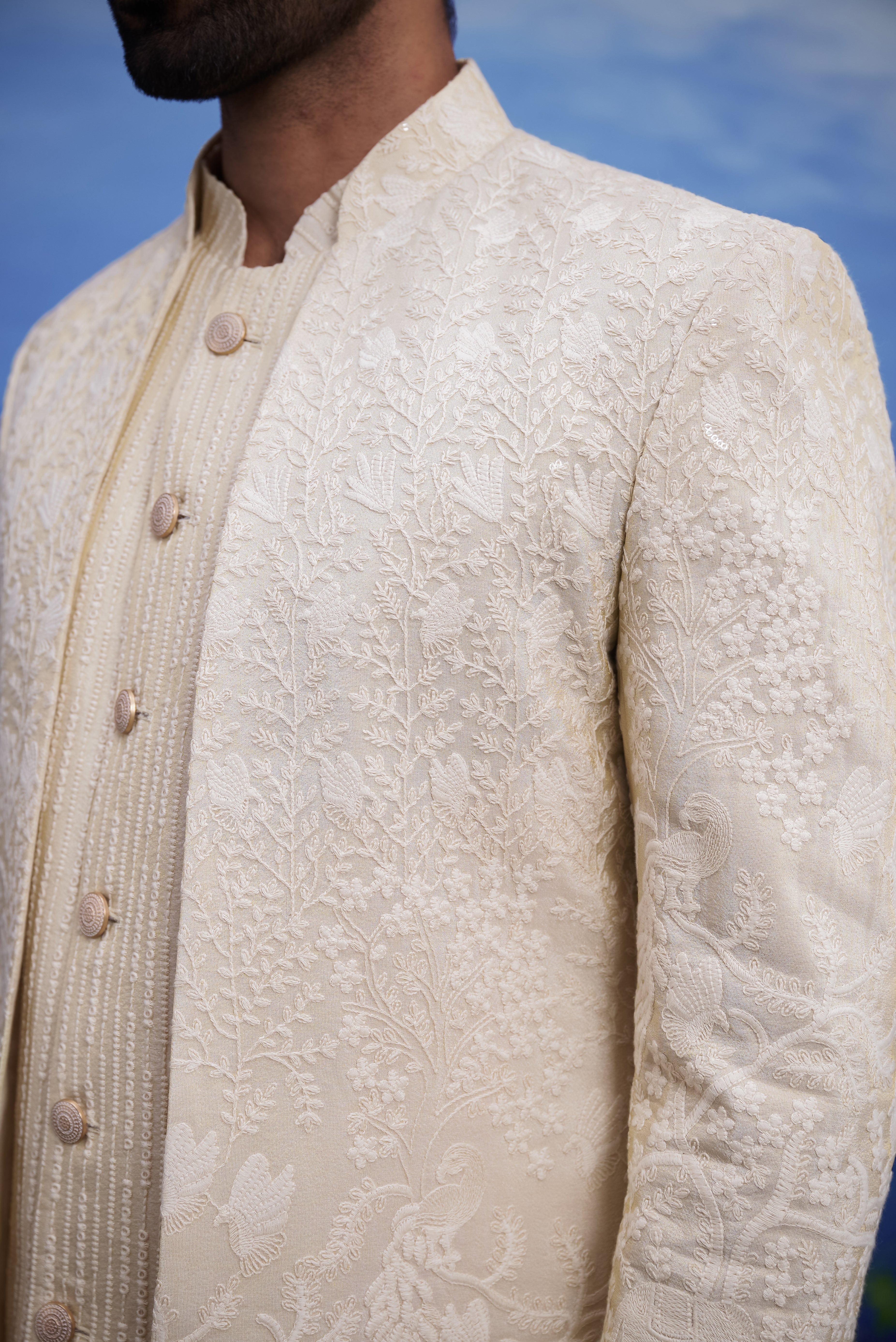 Close-up of the off-white embroidered Indo-western suit, highlighting the embroidered pattern and silk blend fabric texture.