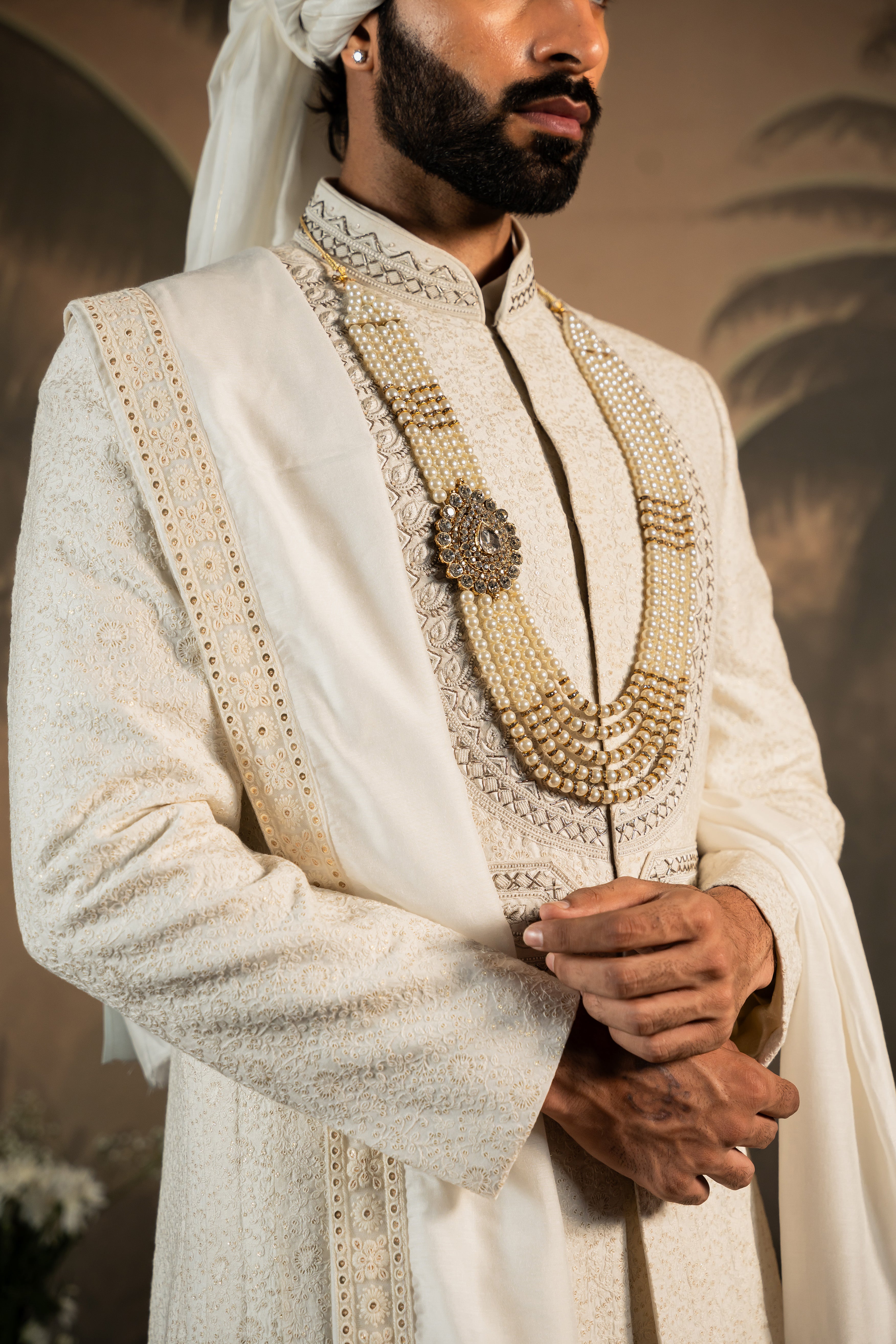 A stylish off-white silk sherwani, perfect for weddings and formal occasions.
