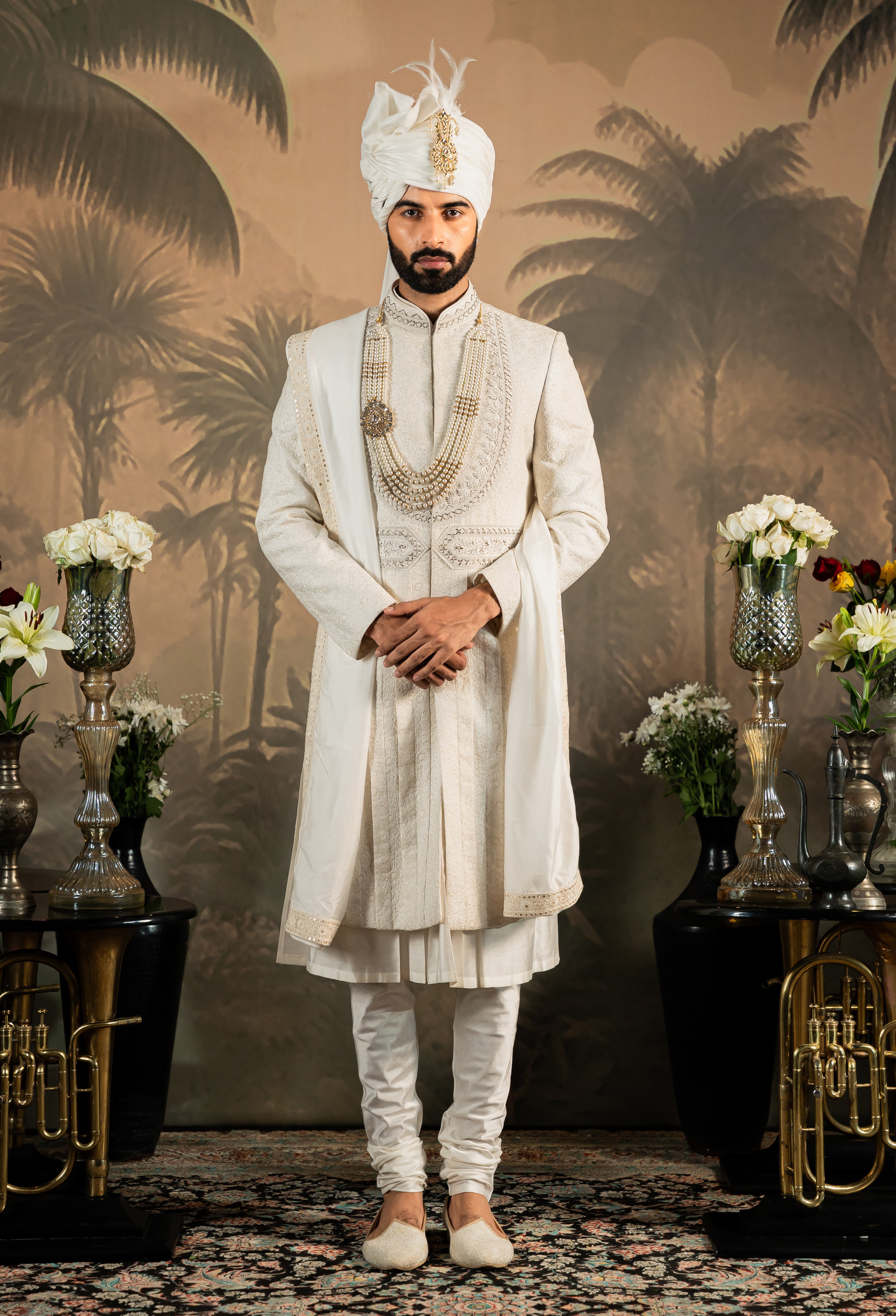 A luxurious off-white silk sherwani set, a timeless classic.
