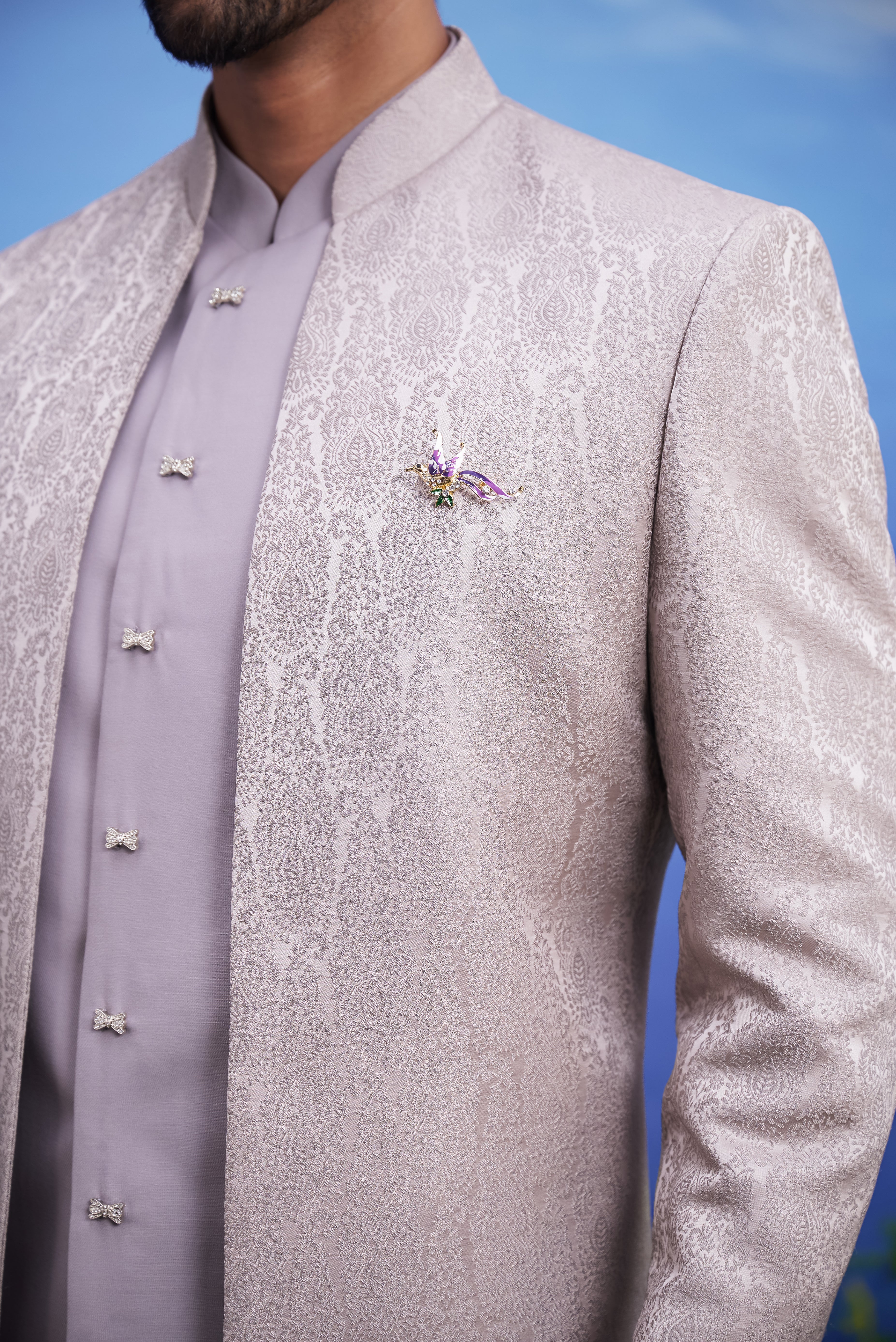 Close-up of the grey jacquard Indo-western suit, highlighting the embroidered pattern and rayon fabric texture.