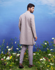 A sophisticated grey Indo-western suit with thread embroidery and an open front, ideal for formal occasions.